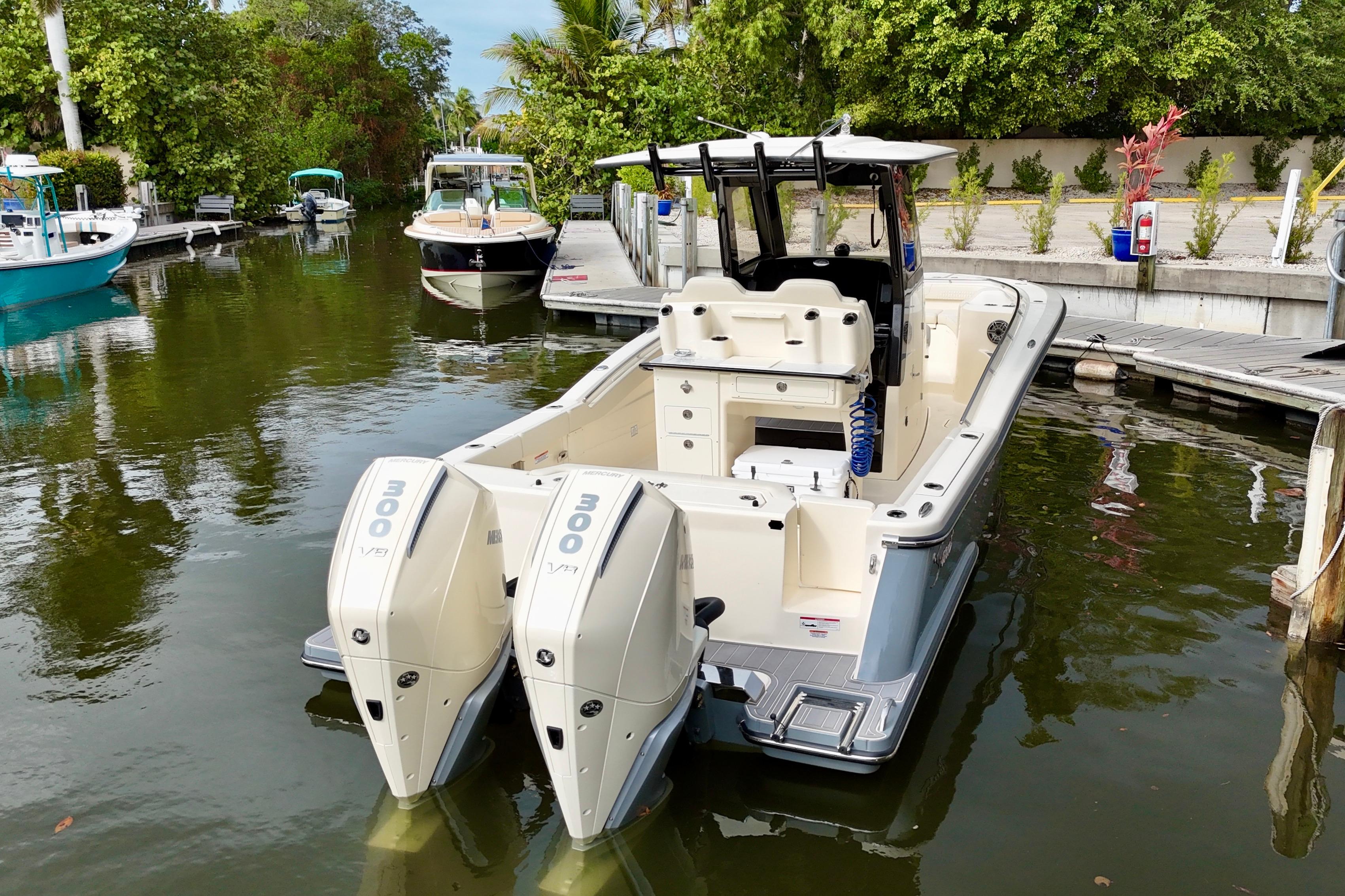 2026 Scout 288 LXF boat docked with twin Mercury 300 V8 engines.