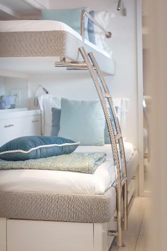 Luxurious 2025 Lagoon SIXTY 5 yacht interior with stylish bunk beds and elegant decor.