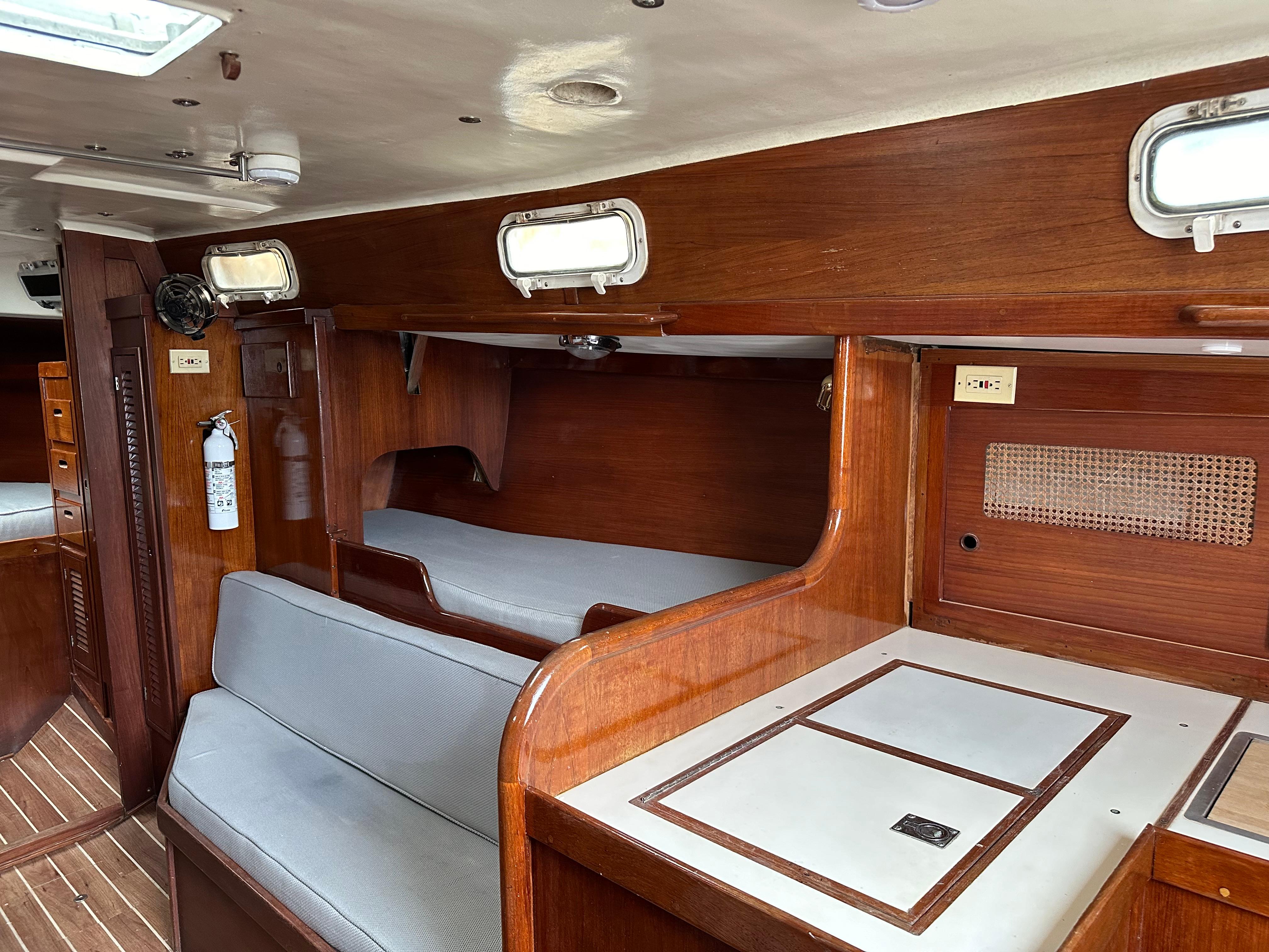 Interior of 1981 Tartan 37 sloop with wooden finish and seating area.