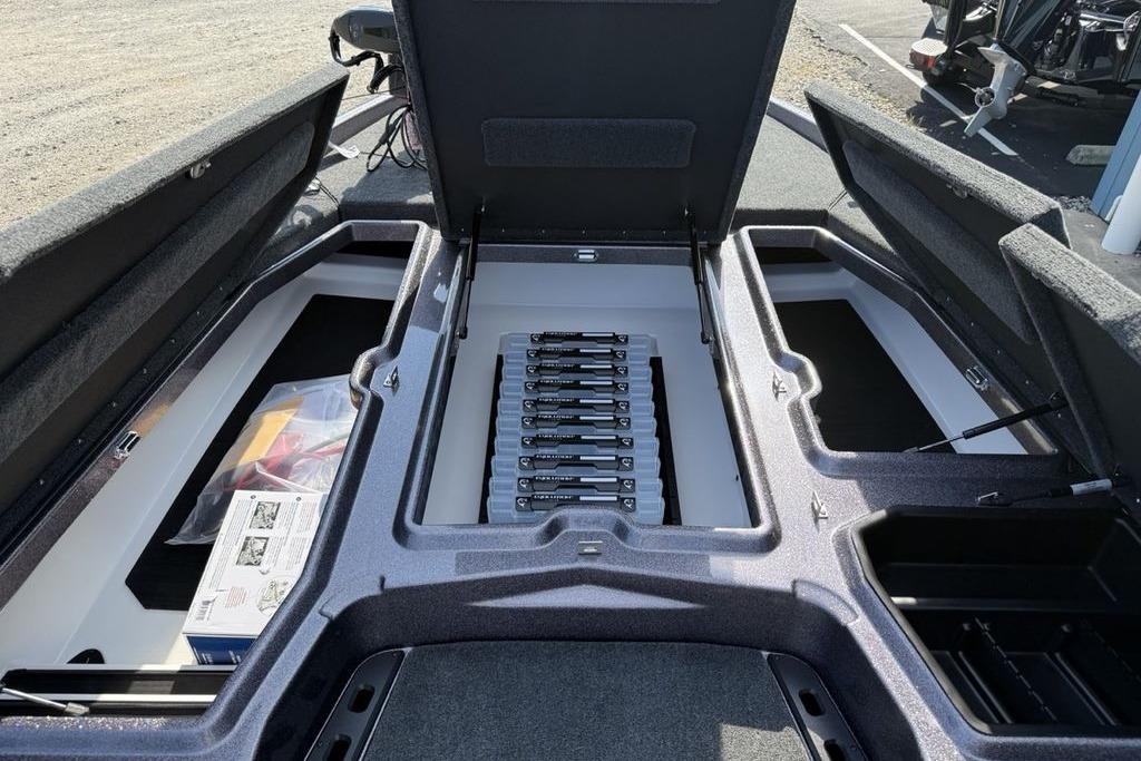Open storage compartments in a 2026 Skeeter ZXE20 boat, showcasing organized interior layout.