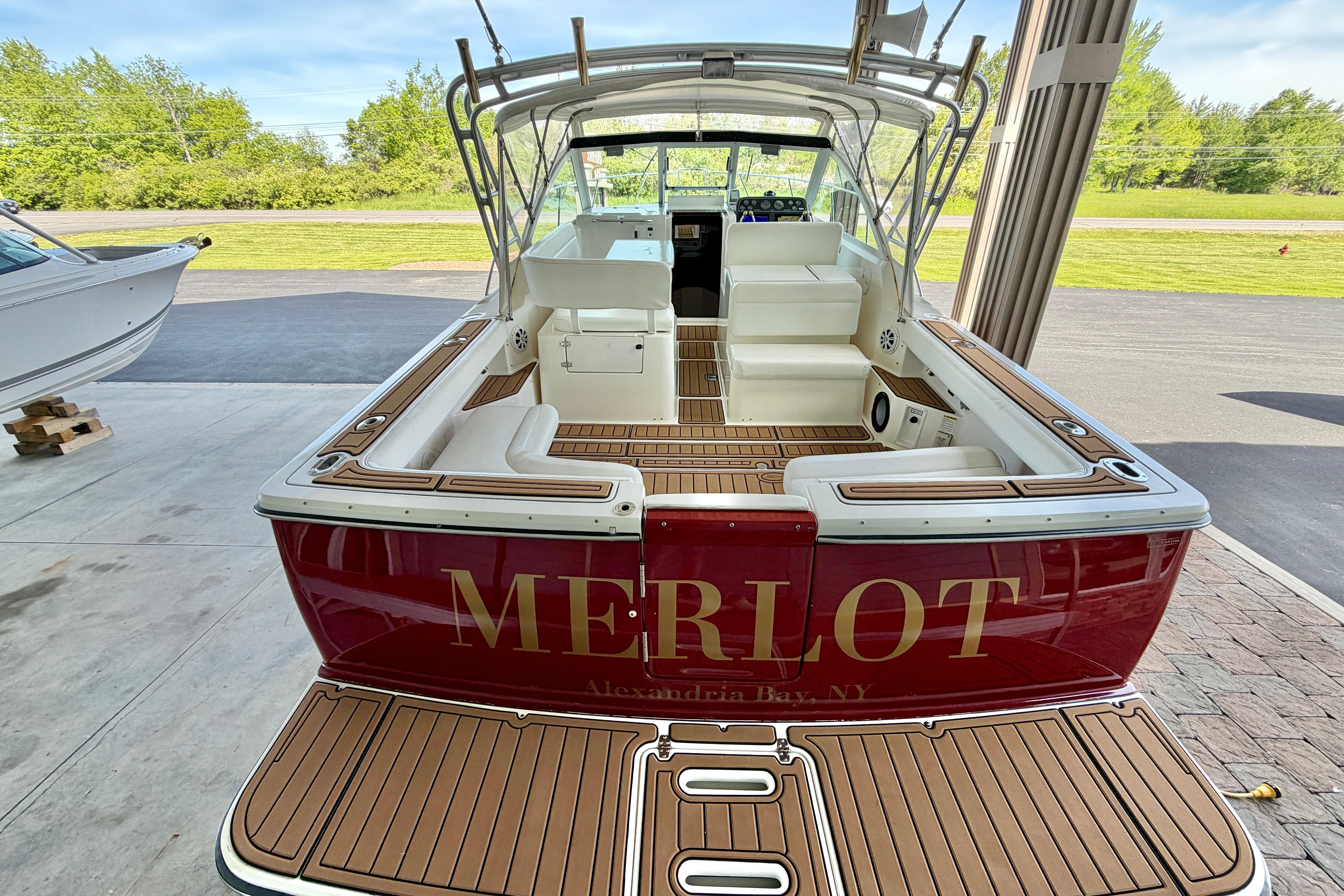 1999 Tiara Yachts 2900 Coronet boat with "MERLOT" name, docked outdoors.