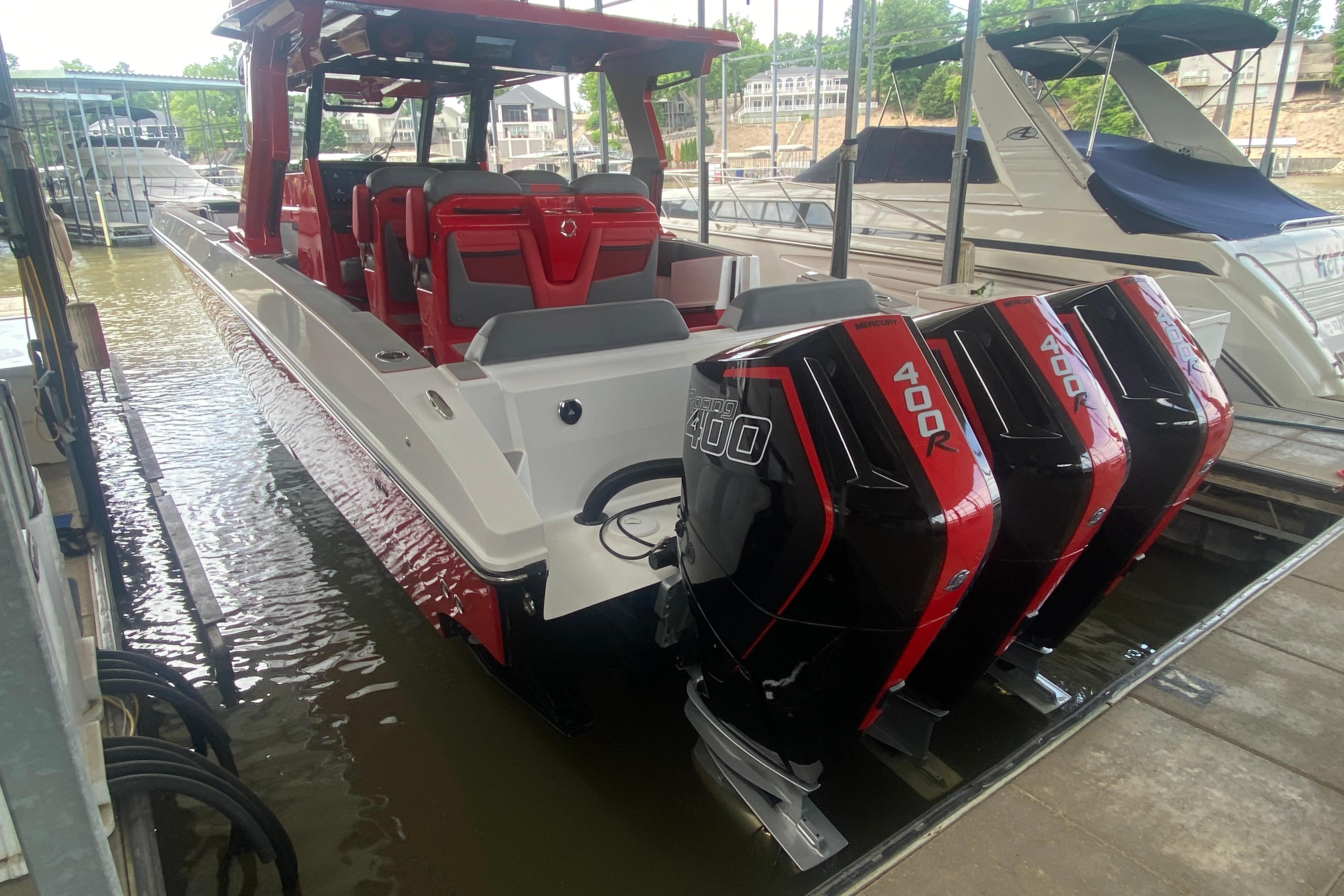 2025 Fountain 38 SCX boat with triple 400R Mercury engines docked at marina.