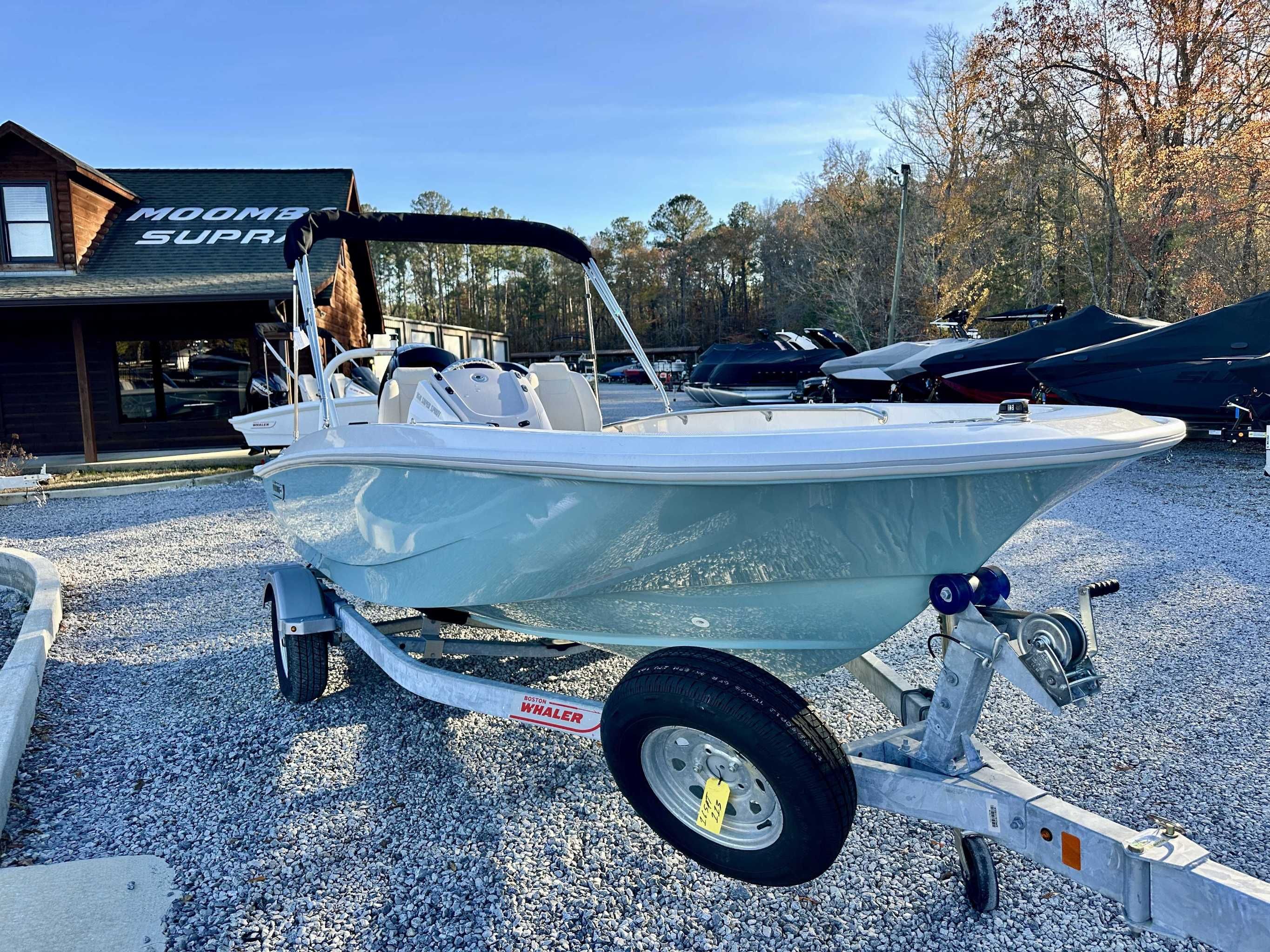 2025 Boston Whaler 160 Super Sport on trailer in front of a building.