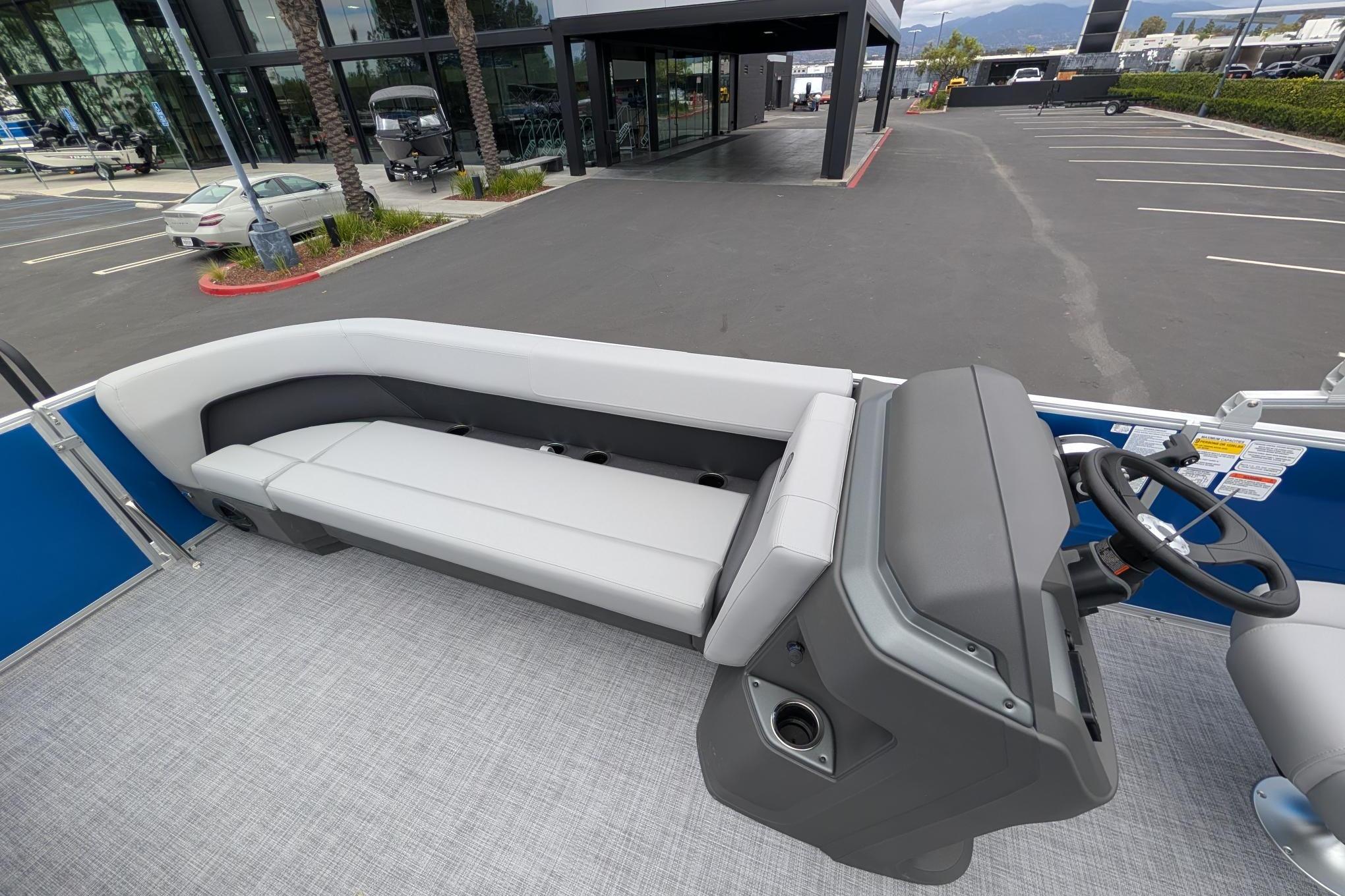 2026 Sun Tracker Party Barge 18 DLX interior with seating and steering console.
