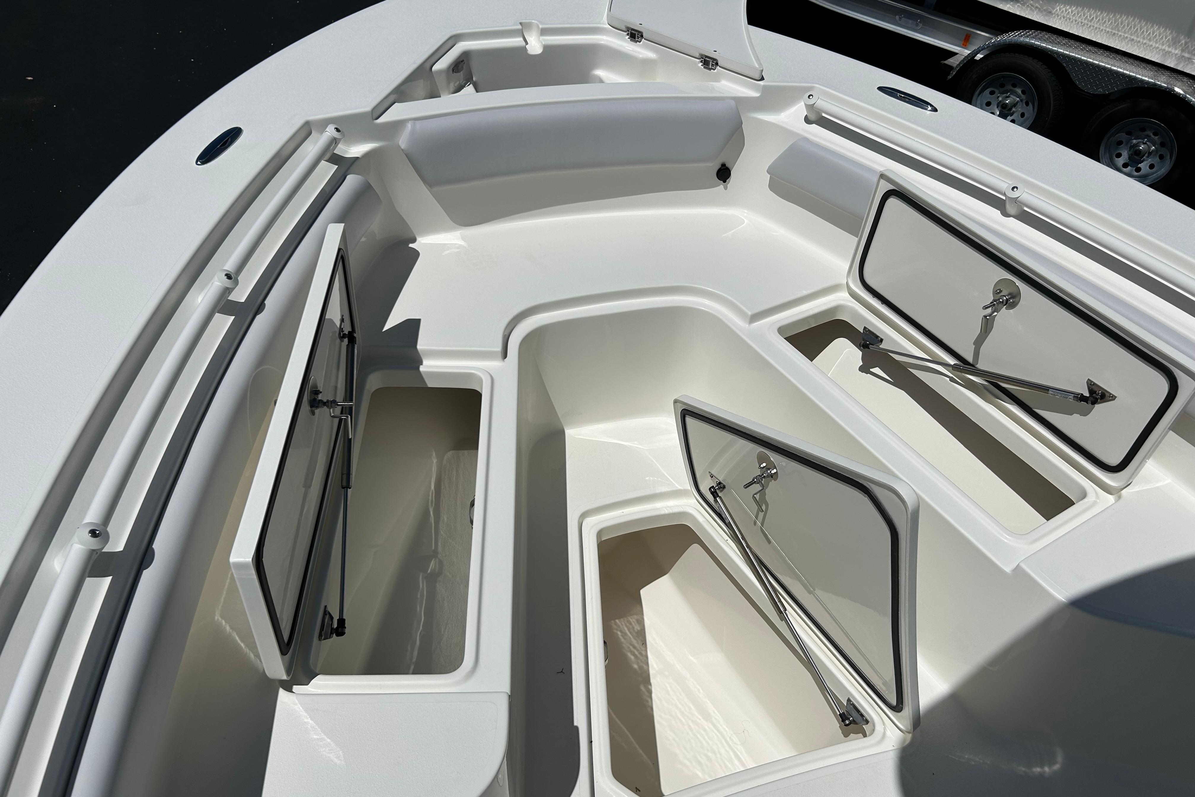 2026 Mako 226 Center Console boat with open storage compartments.