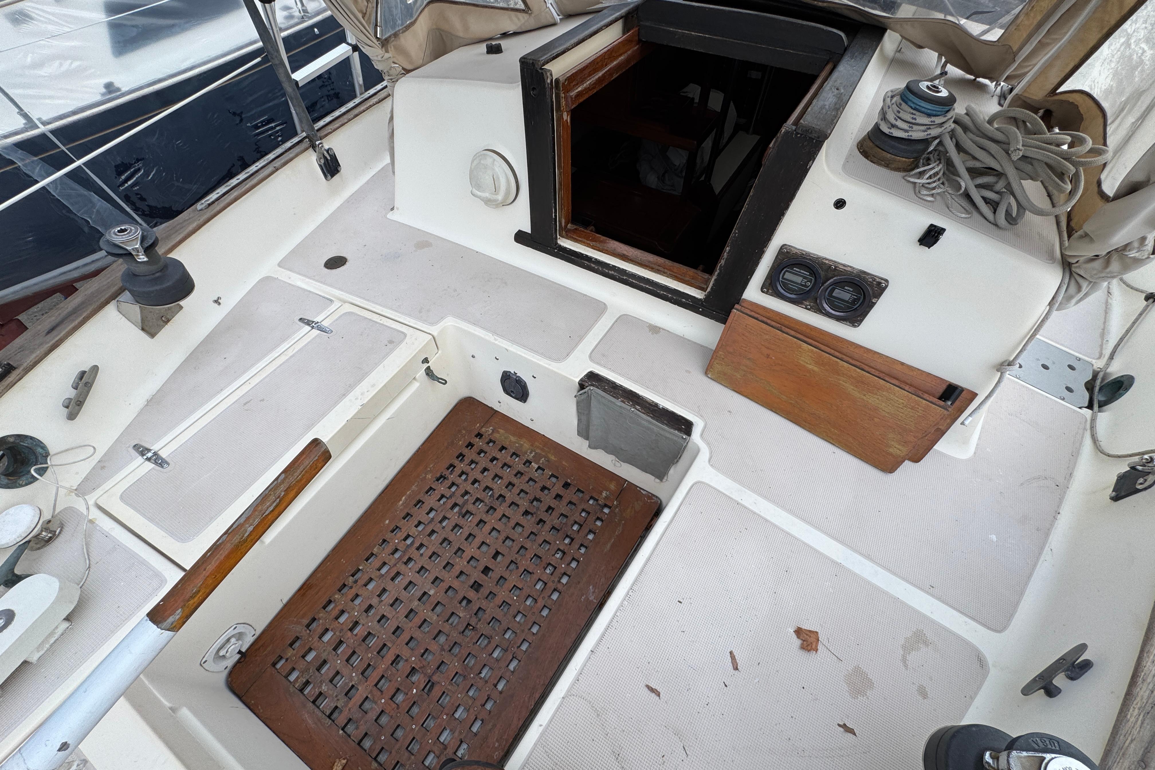 1977 Westsail Cutter cockpit with wooden accents and nautical equipment.