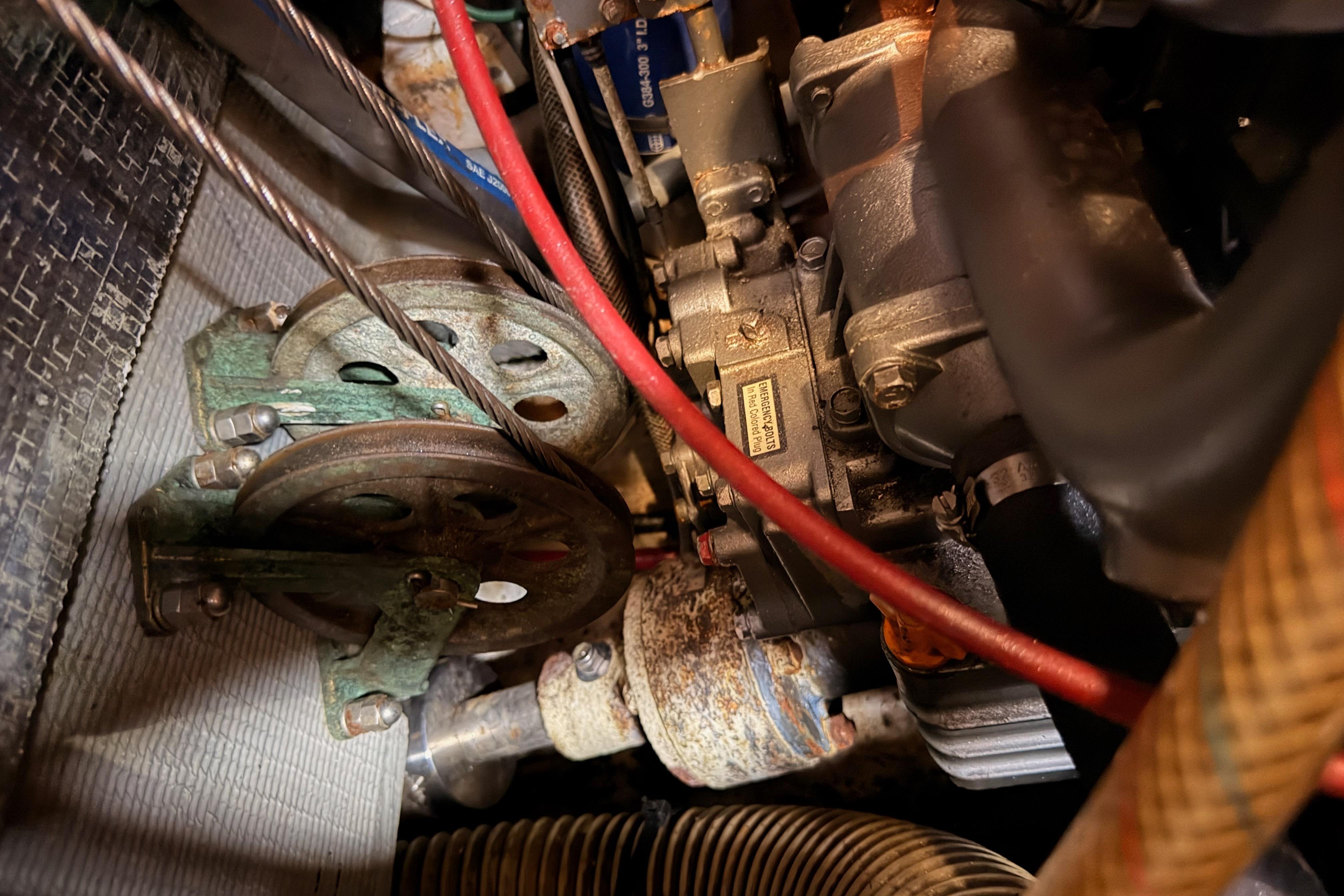 Engine components of a 1991 Hylas 51 yacht, featuring belts and hoses.