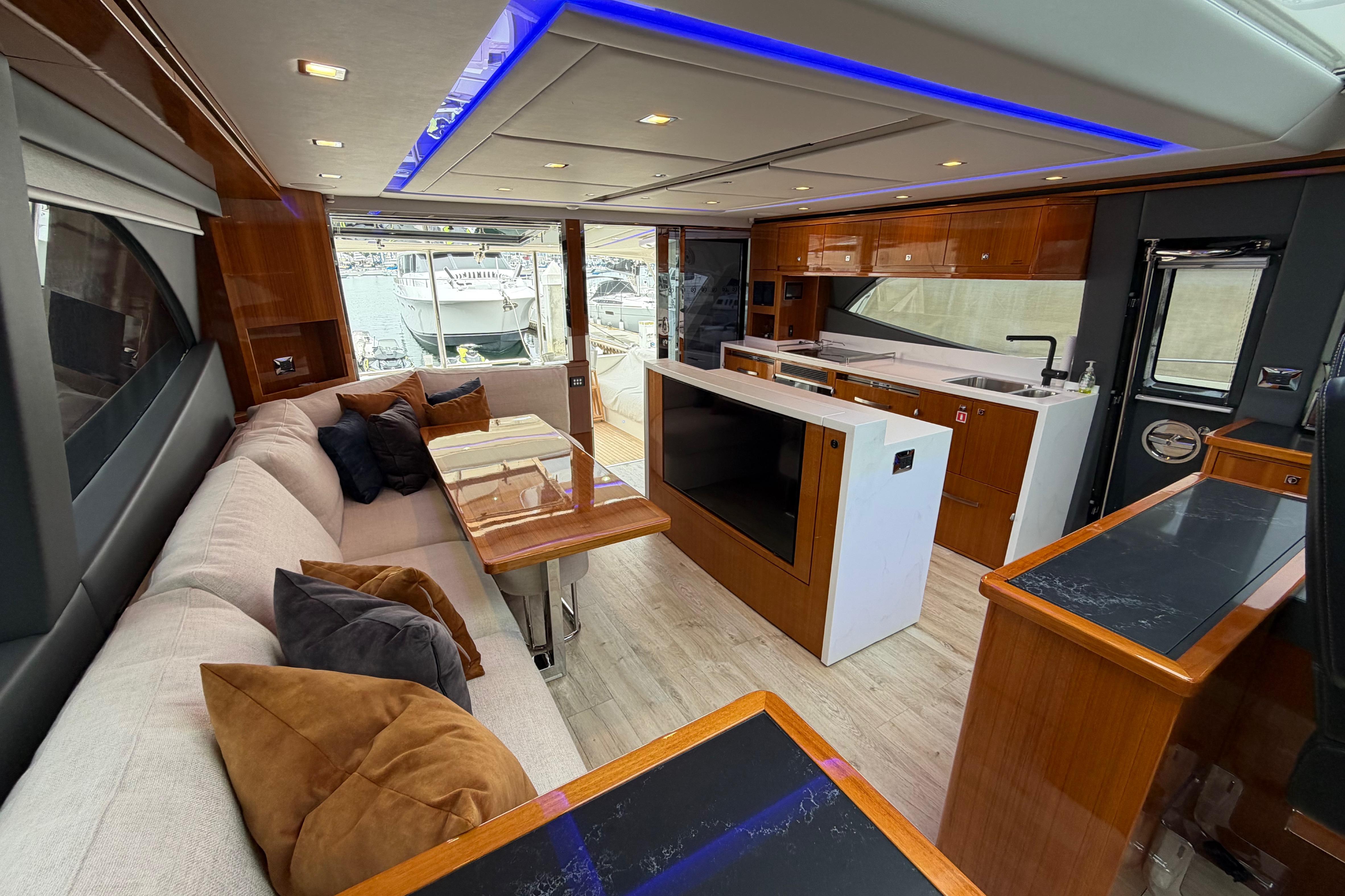 Luxurious interior of 2023 Riviera 645 SUV yacht with modern furnishings and elegant design.