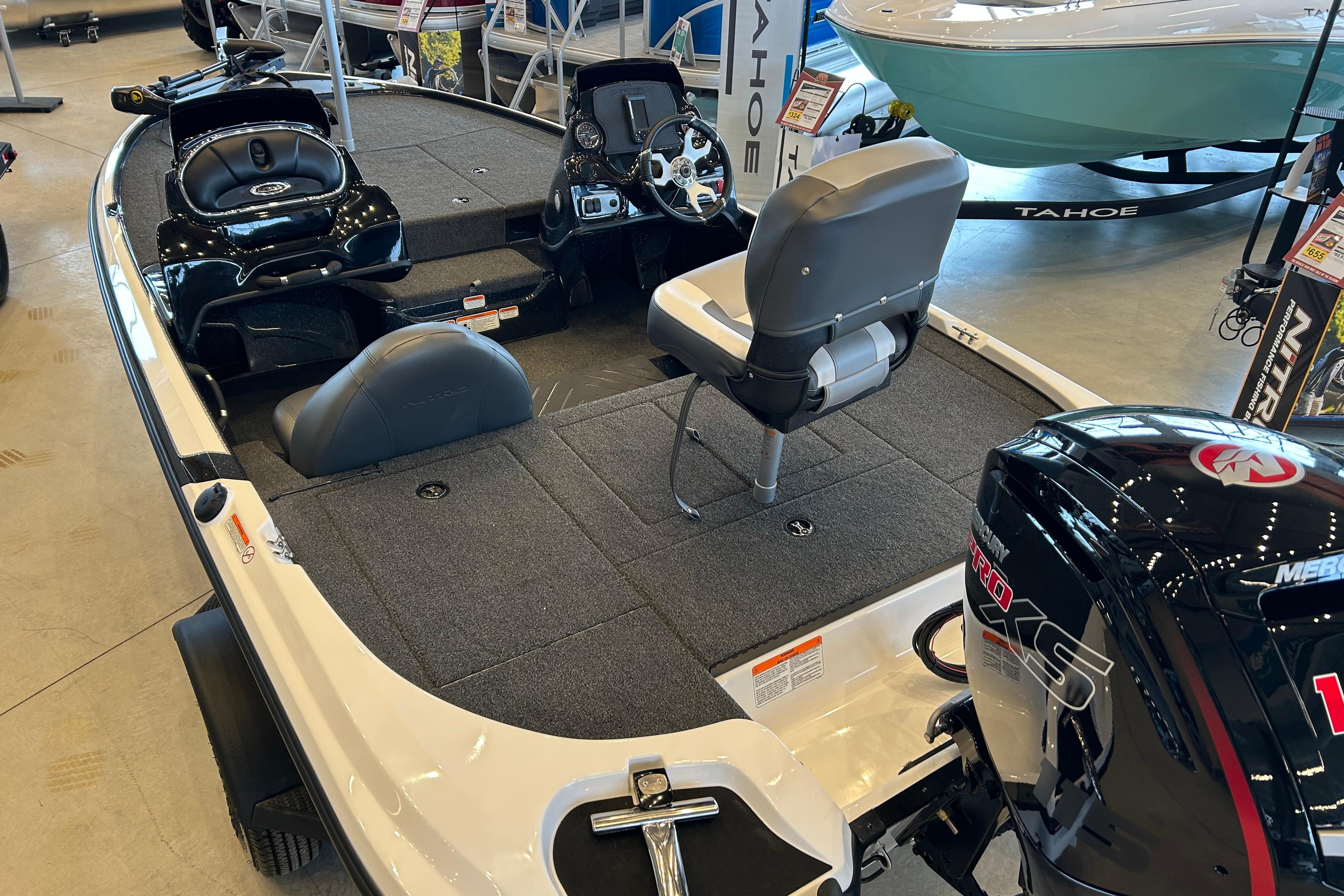 2026 Nitro Z17 boat interior with seating and Mercury engine in showroom.