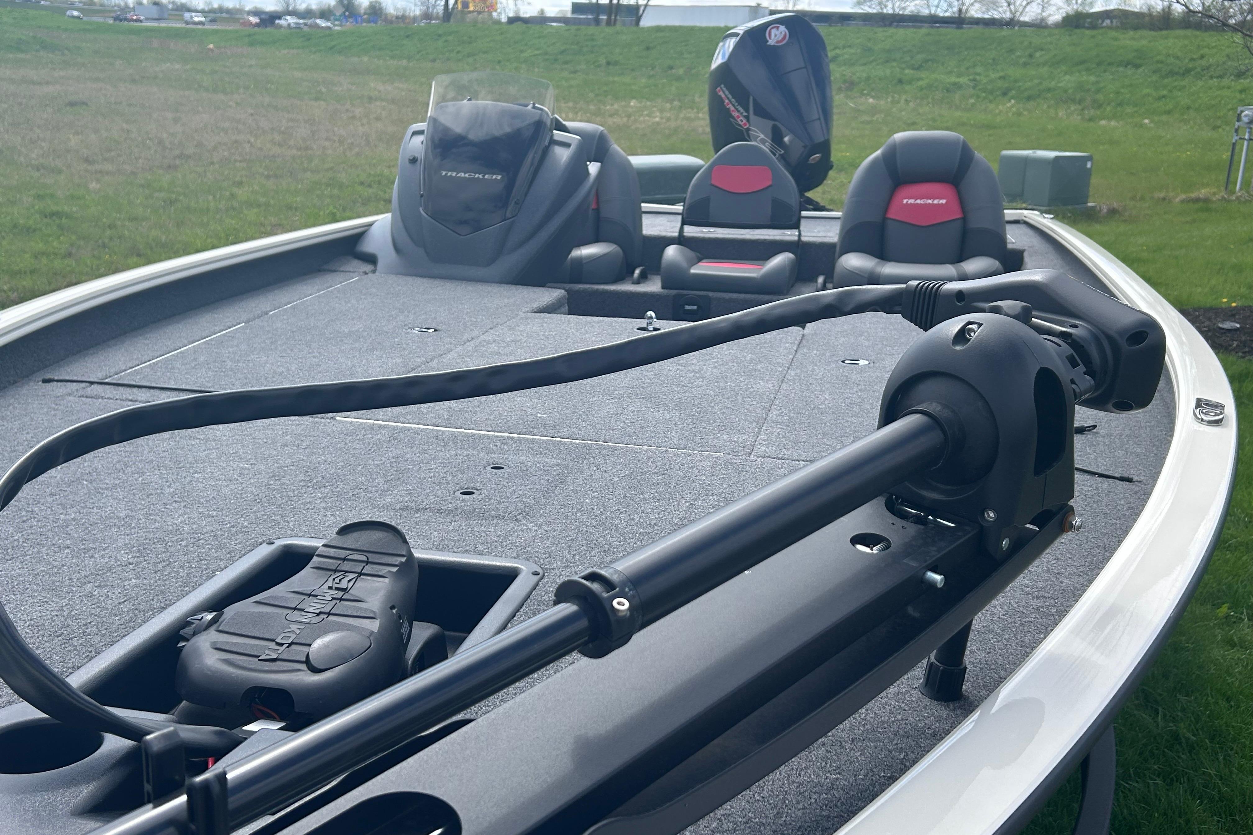 2025 Tracker Savage 215 boat with trolling motor and seating on grassy area.