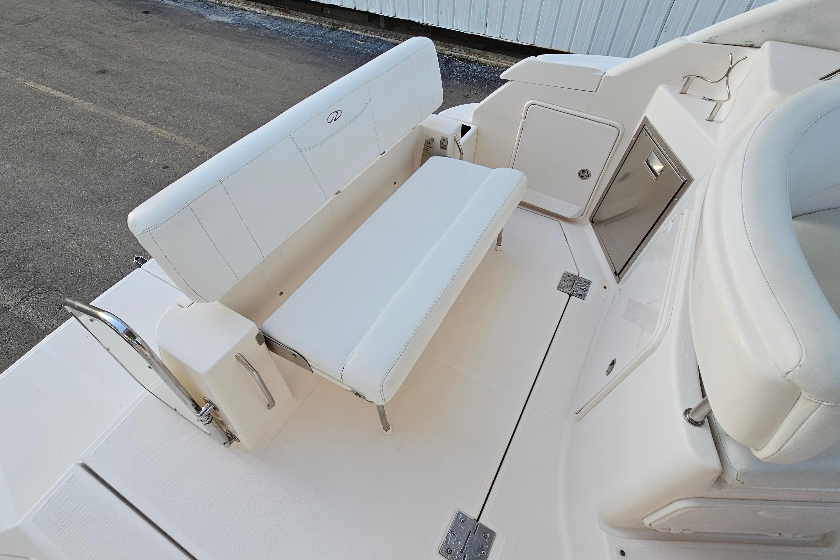 2005 Regal 3060 Window Express boat interior with white seating and storage compartments.