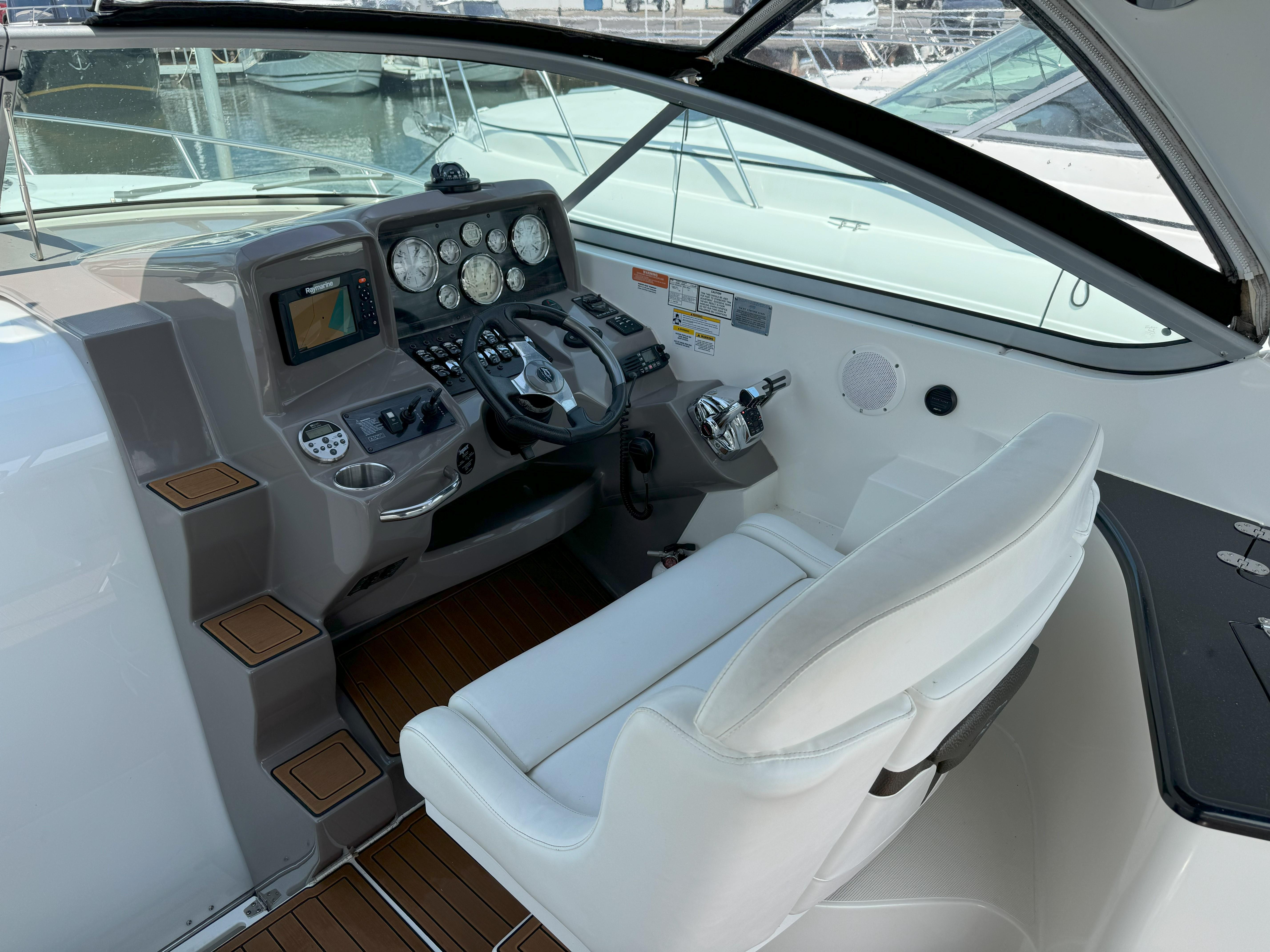 Interior of 2010 Rinker 310 Express Cruiser with helm console.