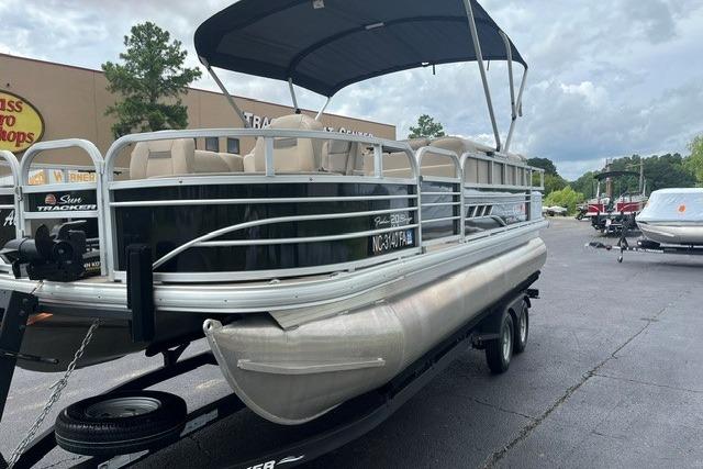 2023 SUNTRACKER Fishing Barge 20 pontoon boat on trailer, parked outdoors.