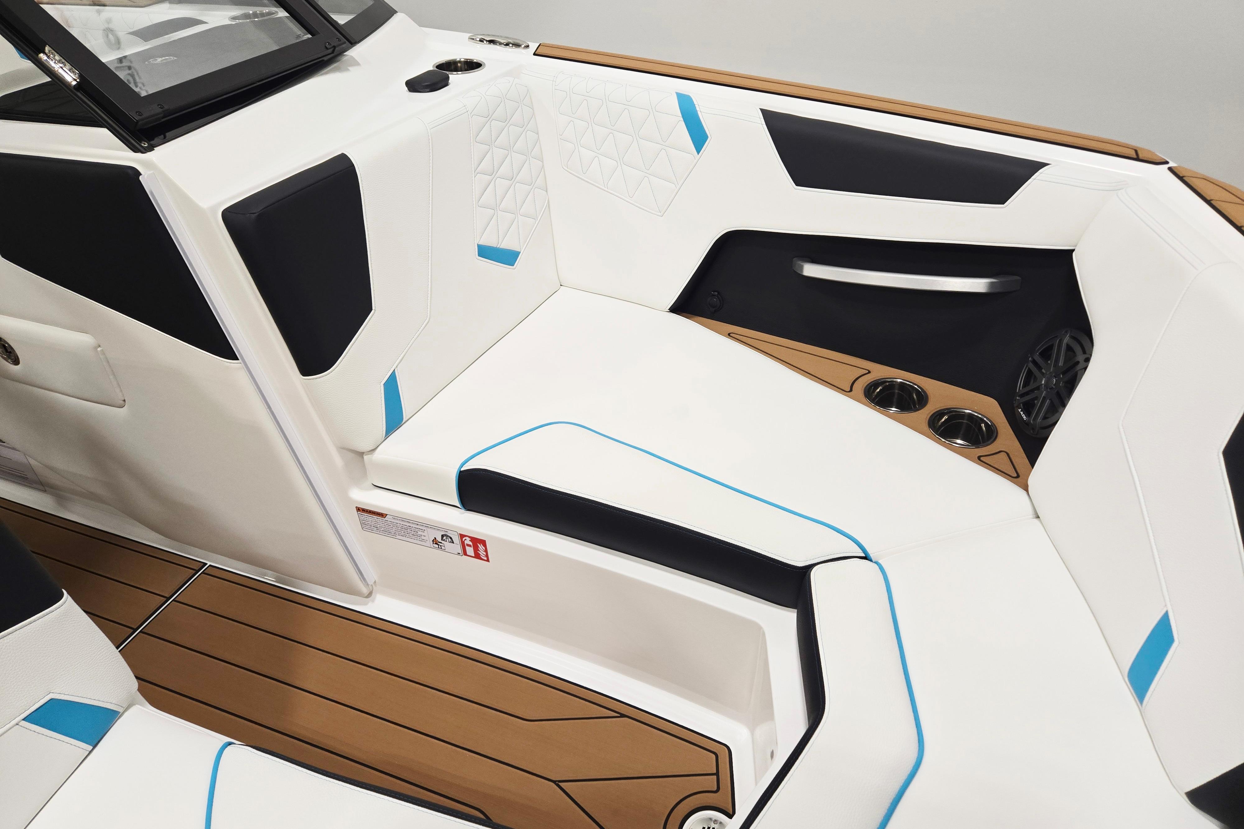 2026 Nautique Super Air Nautique GS22 interior with white and blue seating, cup holders, and modern design.