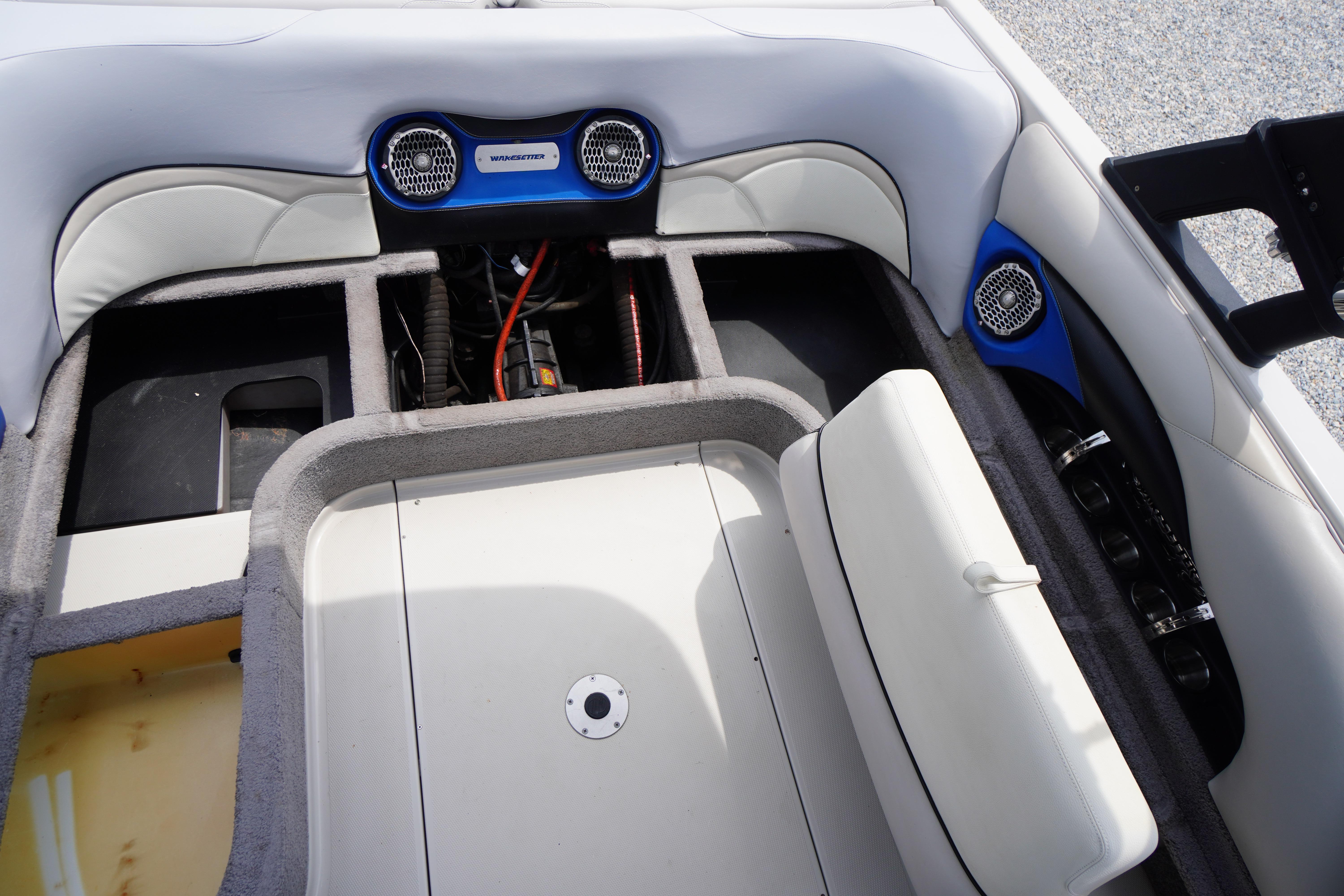 2011 Malibu Wakesetter 21 VLX interior with open storage compartments and speakers.