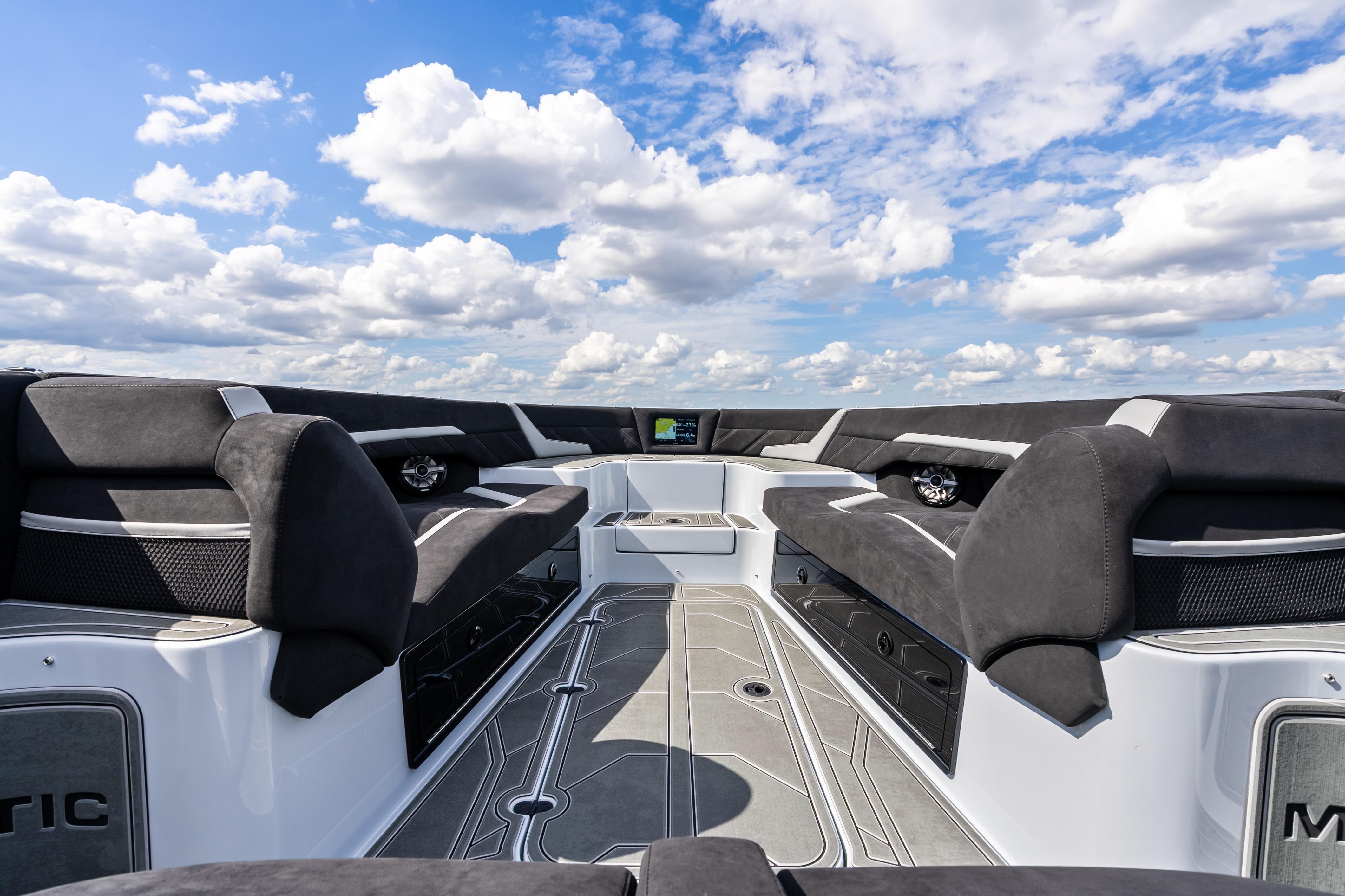 Luxurious interior of 2027 Mystic Powerboats M4200 under a vibrant blue sky.