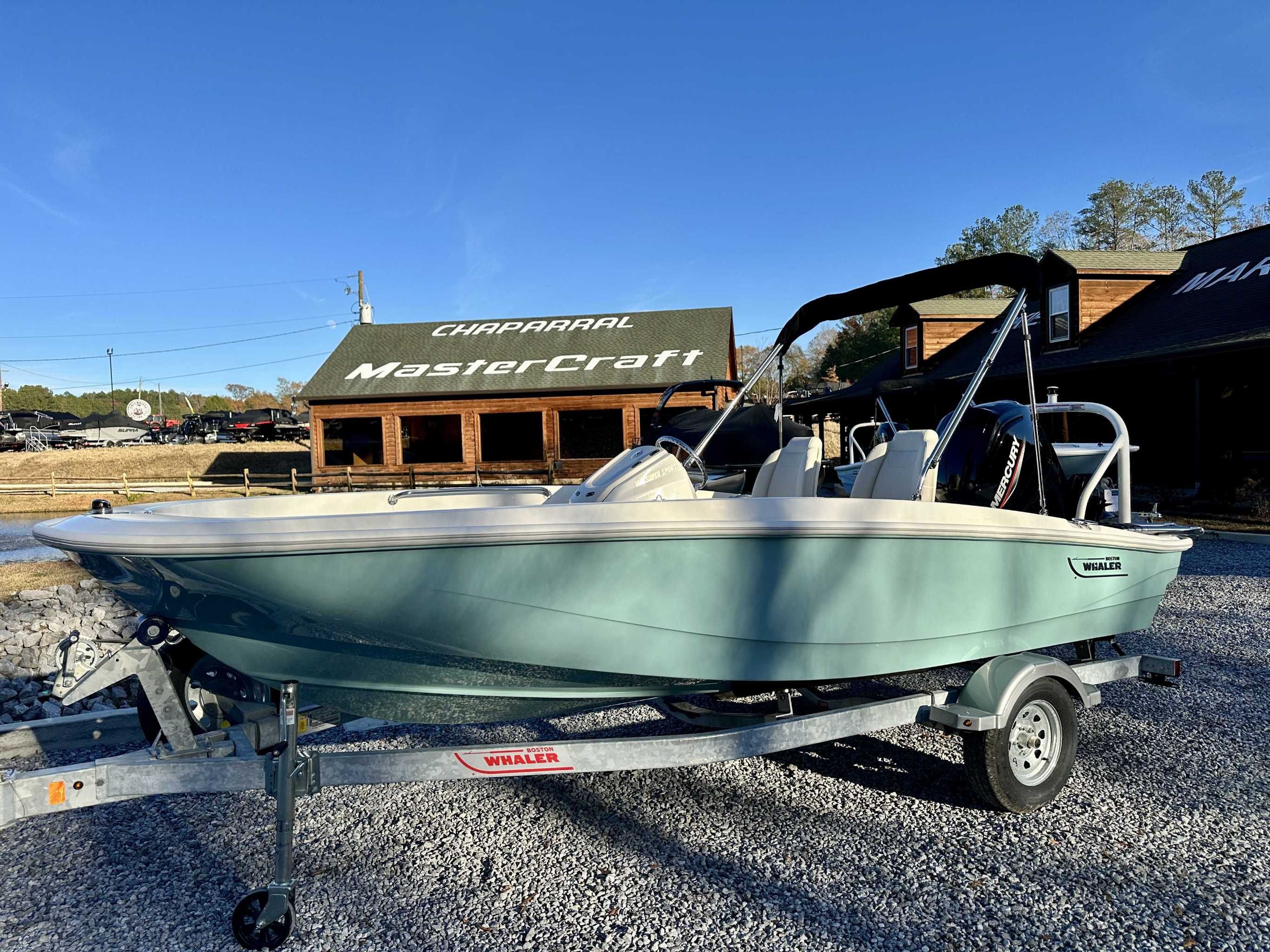 2025 Boston Whaler 160 Super Sport on trailer in front of a store.