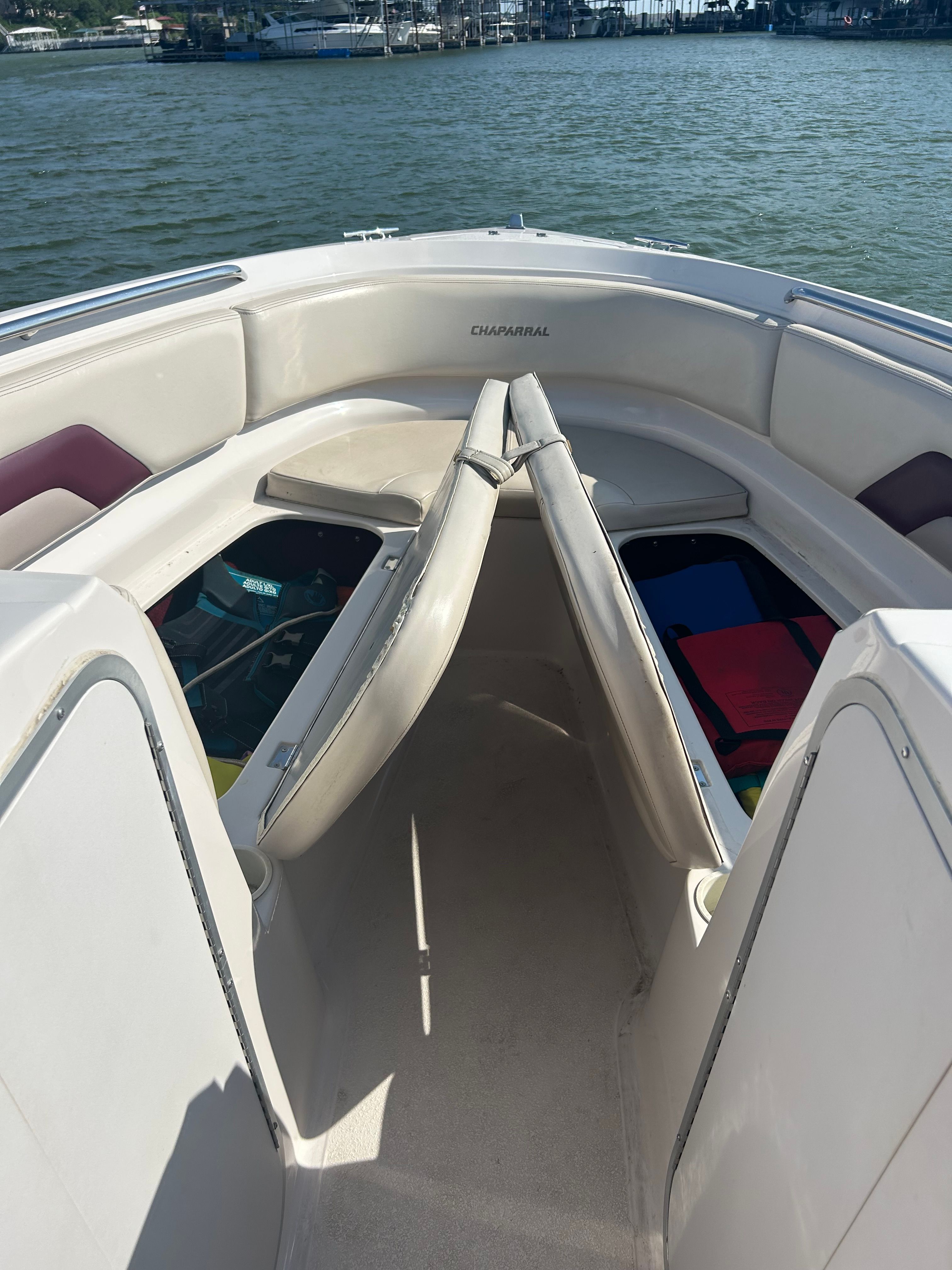 The image shows the bow area of a 1995 Chaparral 2330 boat on the water.