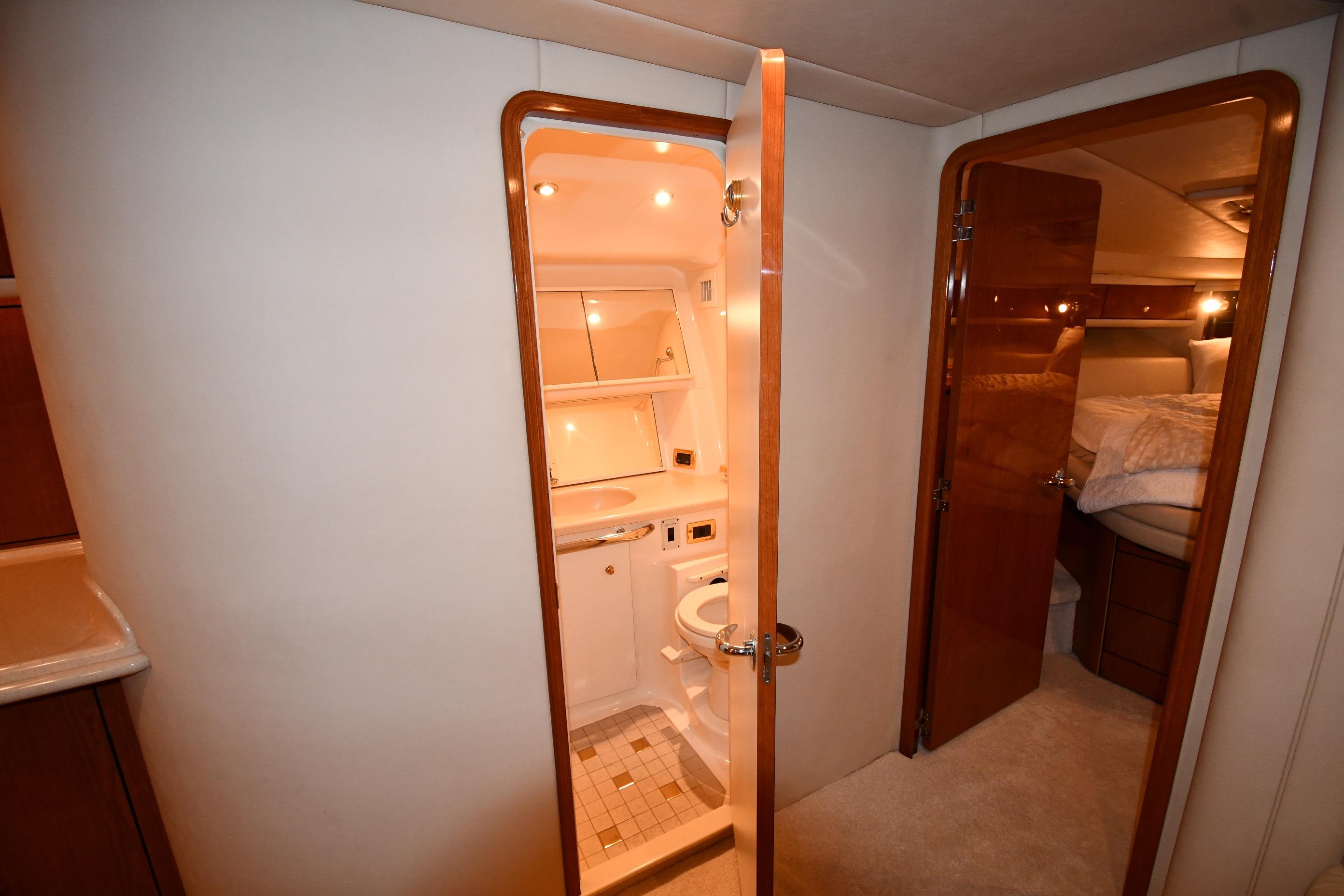 Interior of 2001 Sea Ray 540 Sundancer yacht showing bathroom and bedroom.