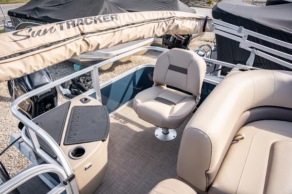 2025 Sun Tracker BASS BUGGY 18 pontoon boat interior with beige seating and console.