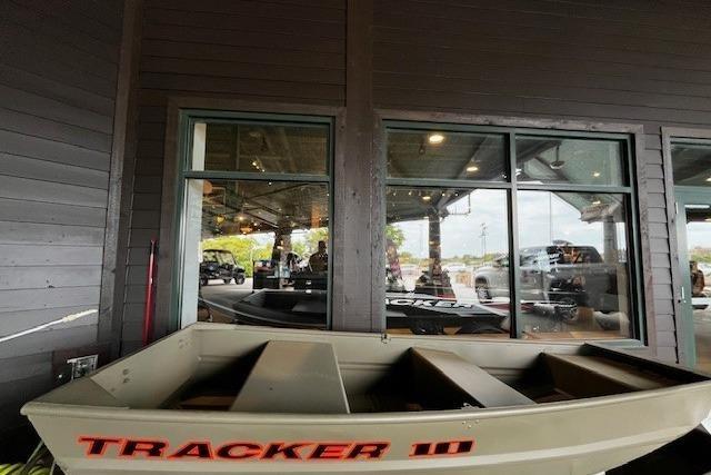 2026 Tracker Grizzly 10 Jon boat displayed indoors near large windows.