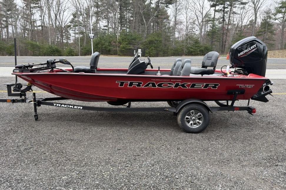 2026 Tracker Pro Team 175 boat on trailer, red color, parked outdoors.