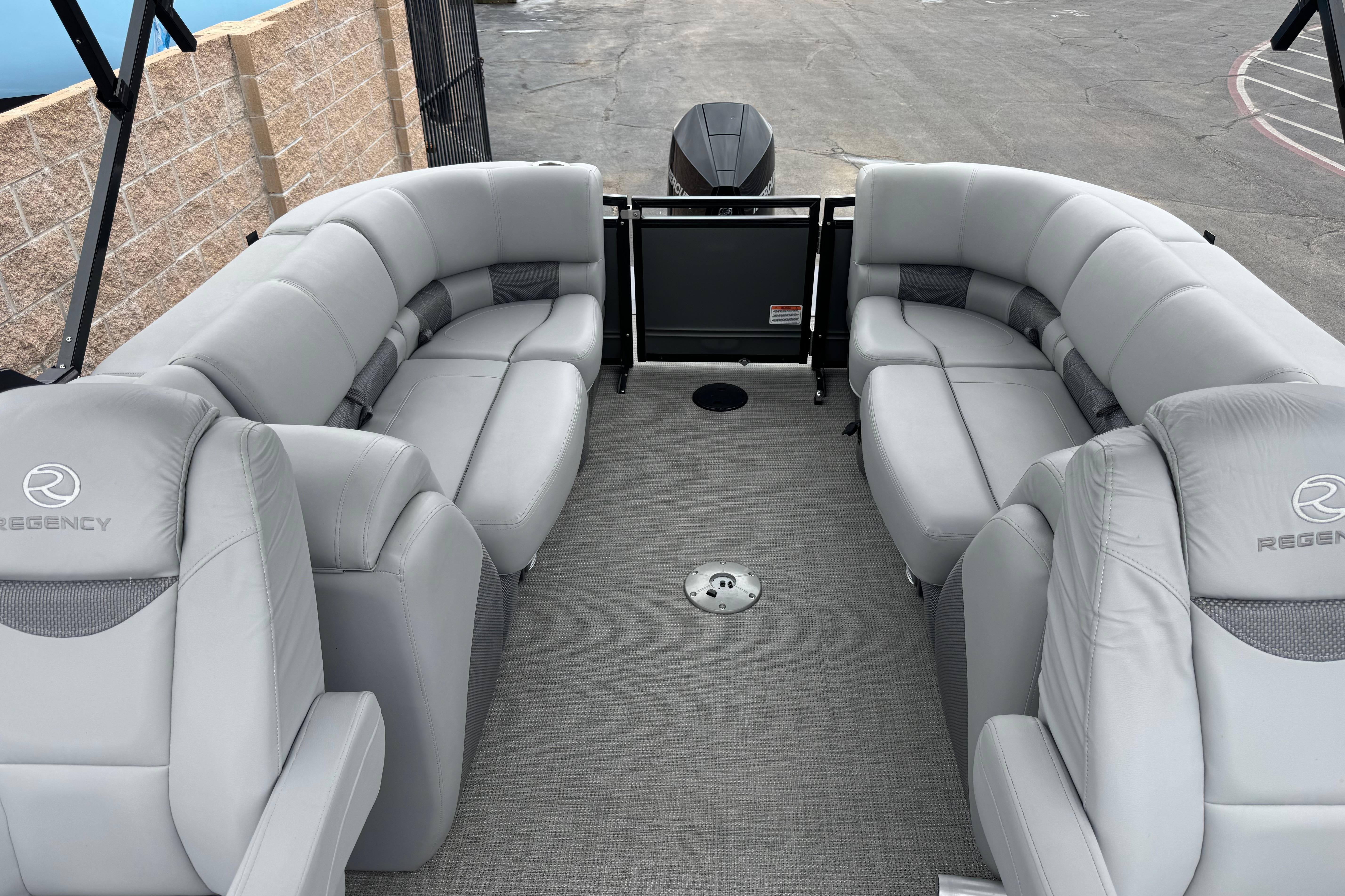 2023 Regency 250 LE3 pontoon boat with luxurious gray seating and spacious deck layout.