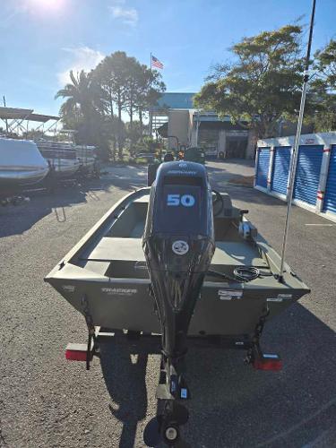 2025 Tracker Grizzly 1648 SC boat with 50 HP motor in sunny outdoor setting.