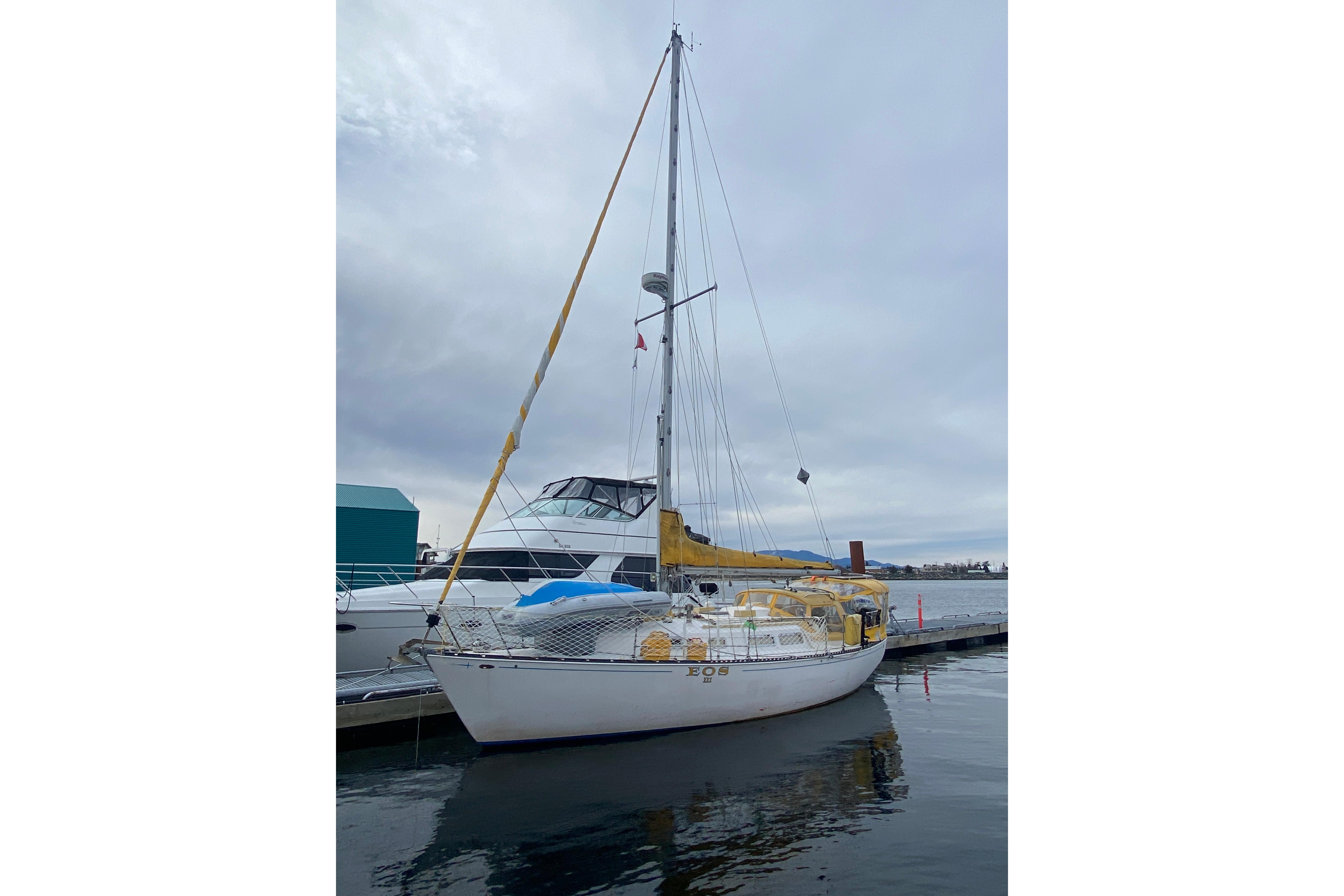 1978 Ontario Yachts Ontario 32 sailboat docked at marina under cloudy sky.