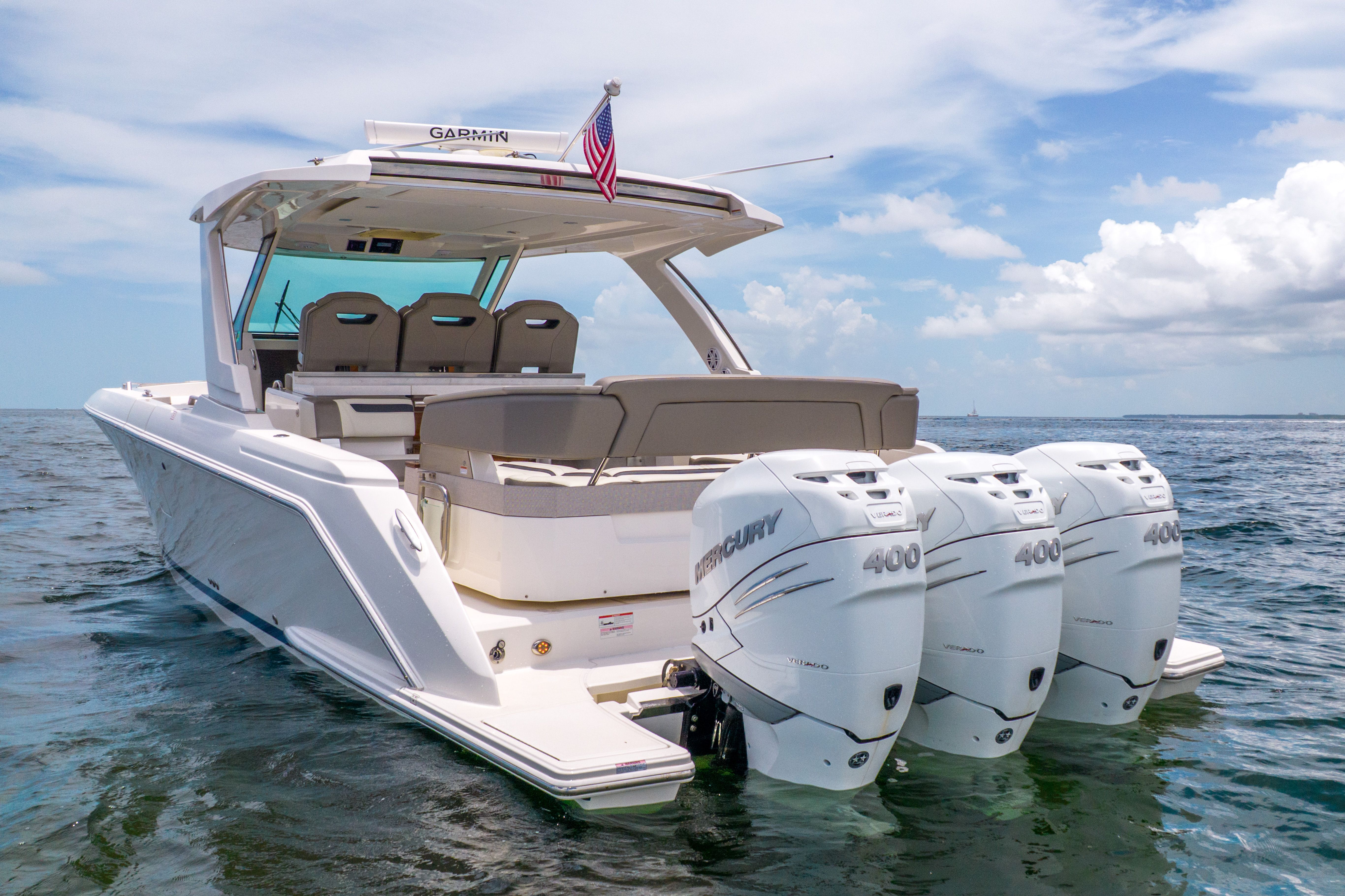 2023 Tiara Yachts 38 LS with three Mercury engines on calm water.
