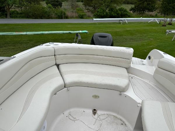2004 Starcraft Aurora 2410 boat interior with white cushioned seating on grassy area.