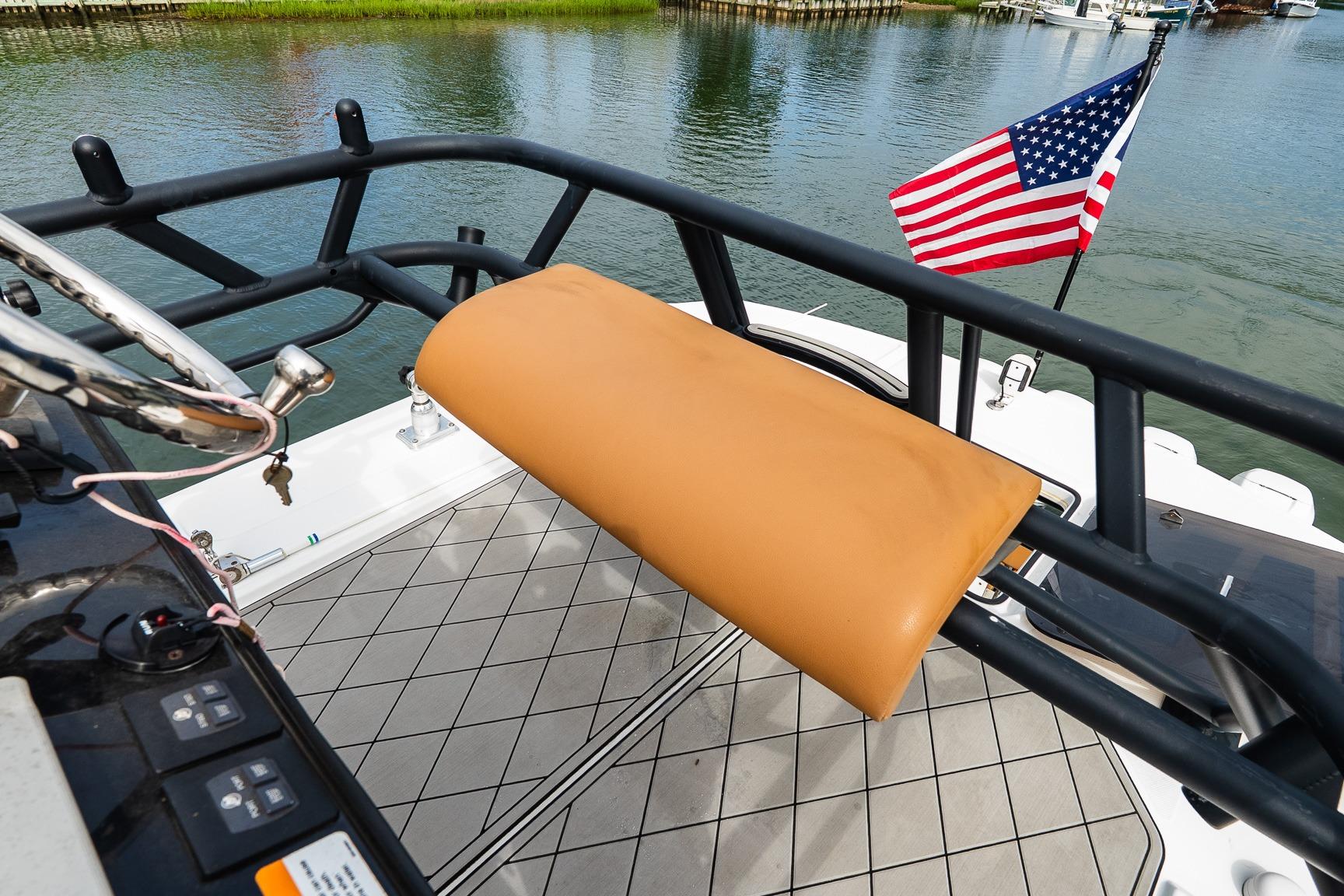 2021 Wellcraft 402 Fisherman boat deck with American flag and cushioned rail.