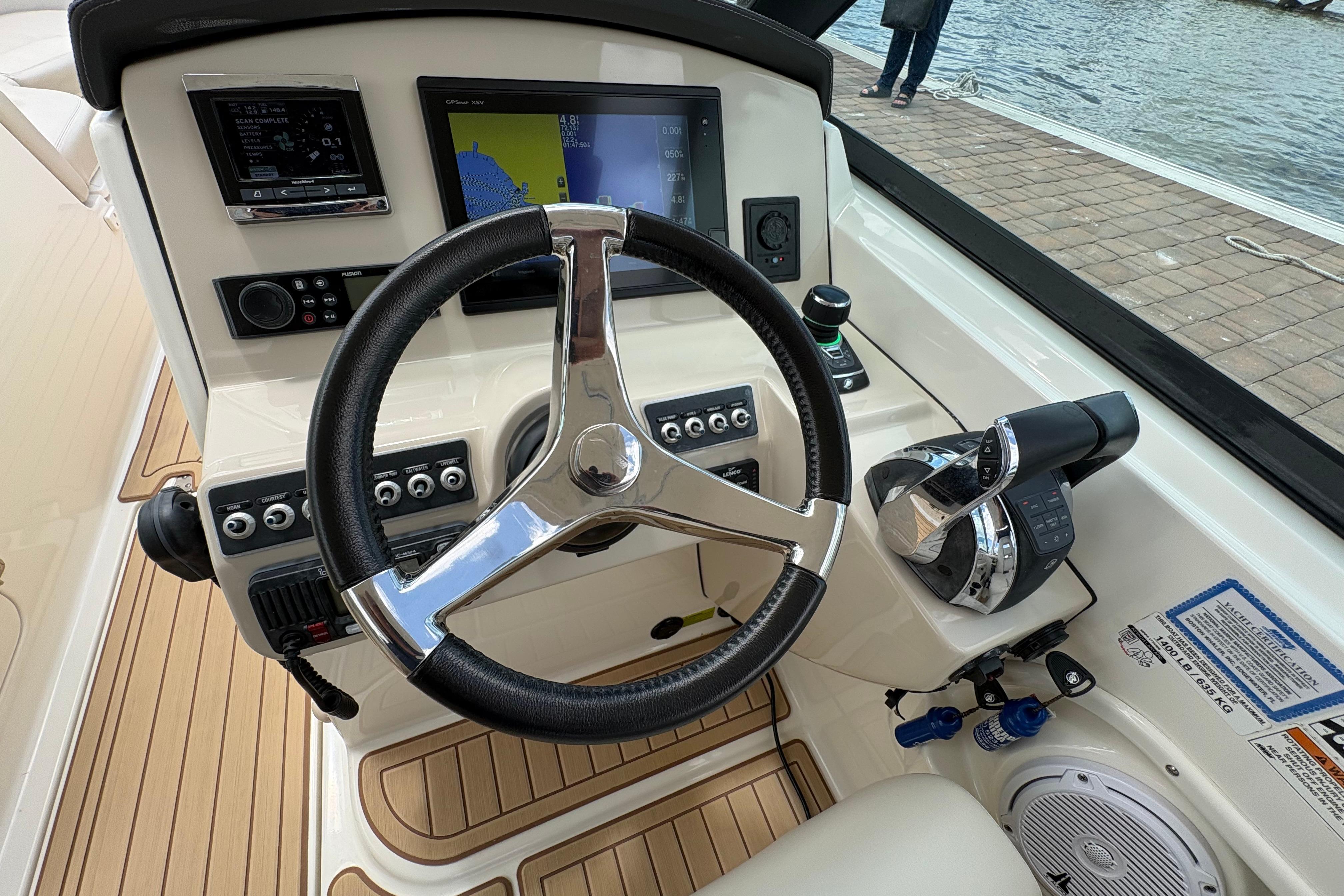 Steering console of a 2017 Boston Whaler 270 Vantage boat with modern controls.