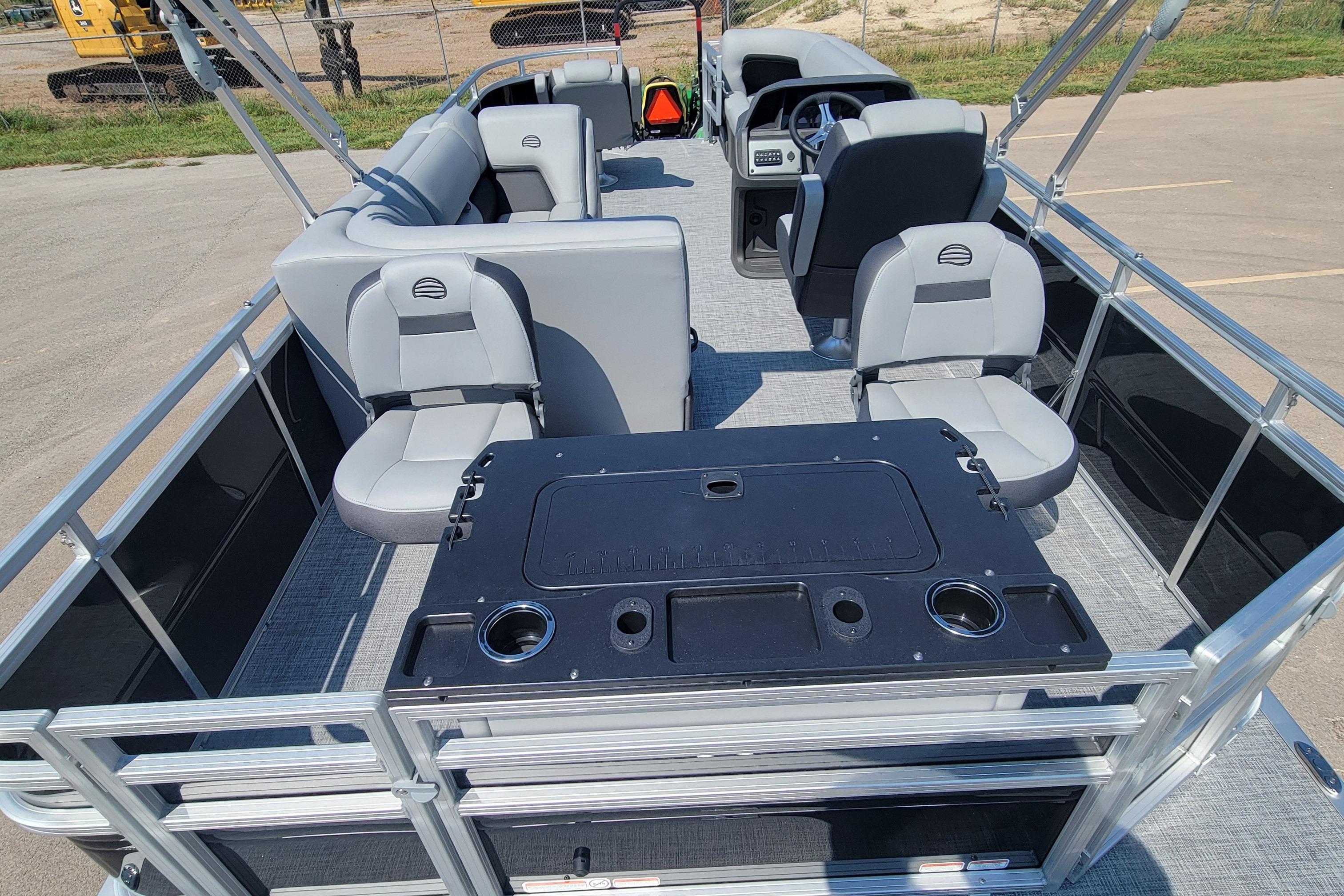 2026 Sun Tracker SportFish 20 DLX pontoon boat interior with seating and control console.