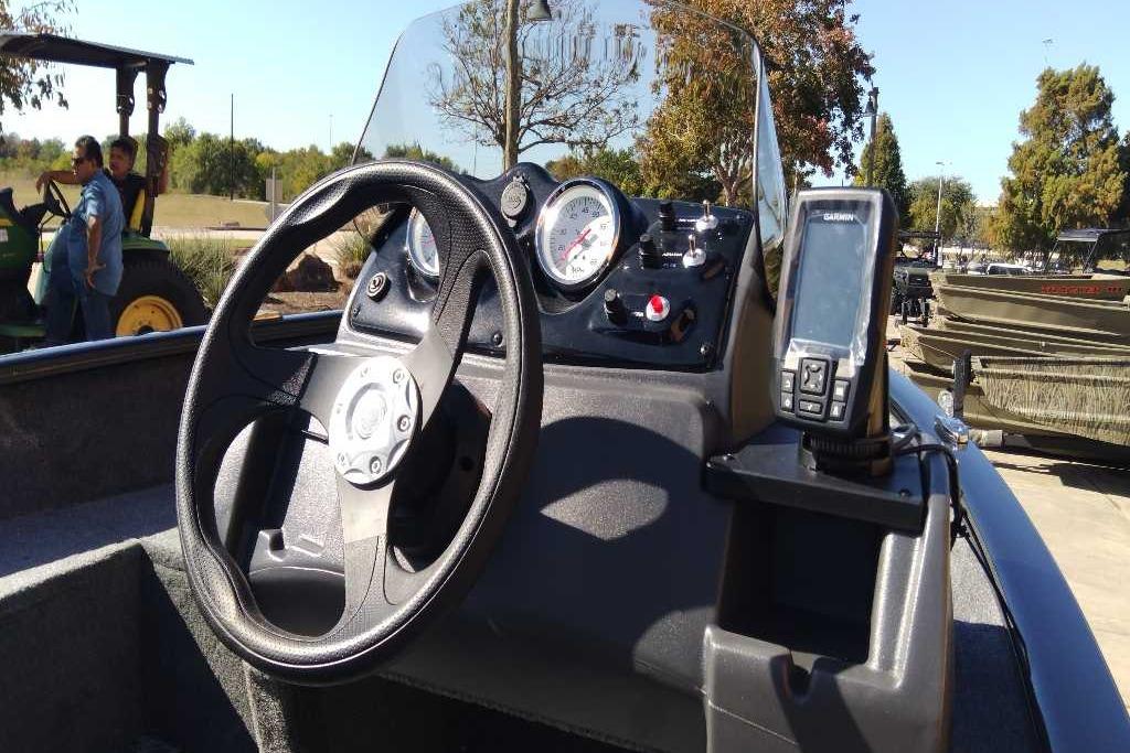 2026 Tracker Super Guide V-16 SC boat dashboard with steering wheel and navigation system.