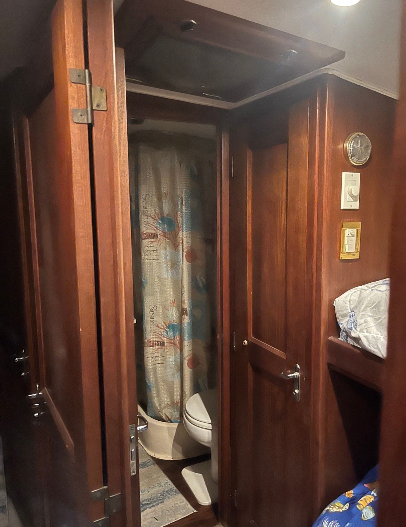 Interior of a 1979 Hatteras sport fishing boat with wooden doors and a small bathroom.