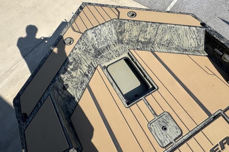 2026 Tracker Grizzly 1756 T Marsh boat interior with camouflage design and storage compartment.