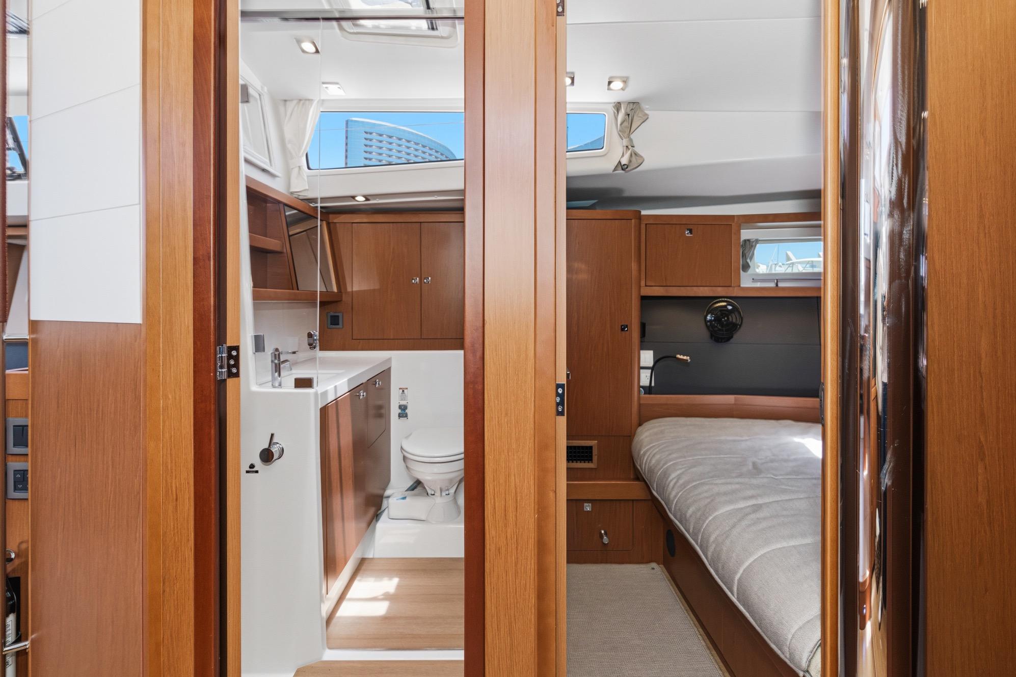 Interior of 2017 Beneteau Sense 50 yacht, featuring a cozy cabin and modern bathroom.