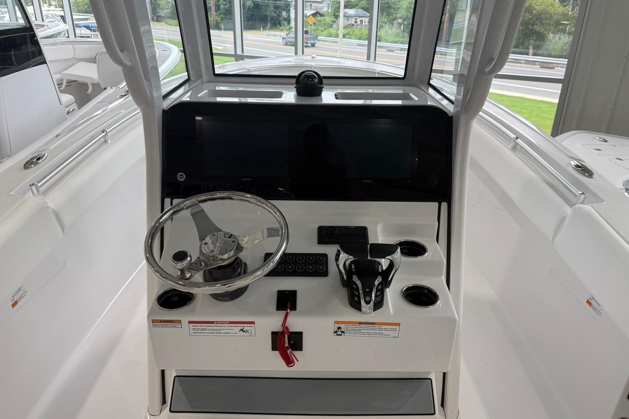 2026 Sportsman Open 252 Center Console boat interior with steering wheel and control panel.