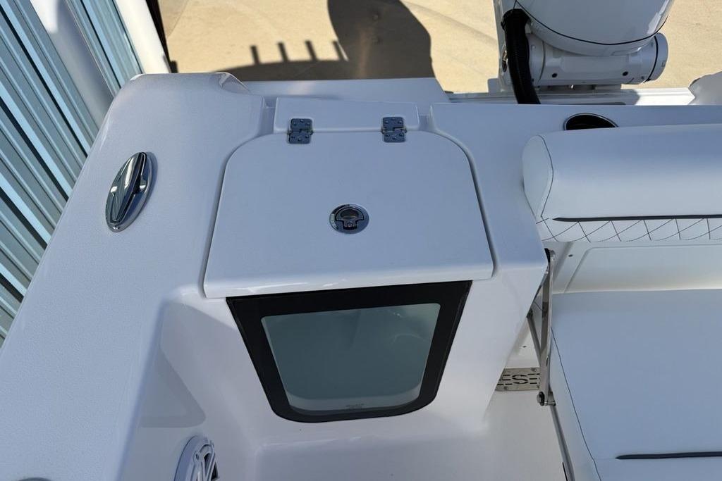 2026 Sportsman Open 232 Center Console boat interior, featuring seating and storage compartment.