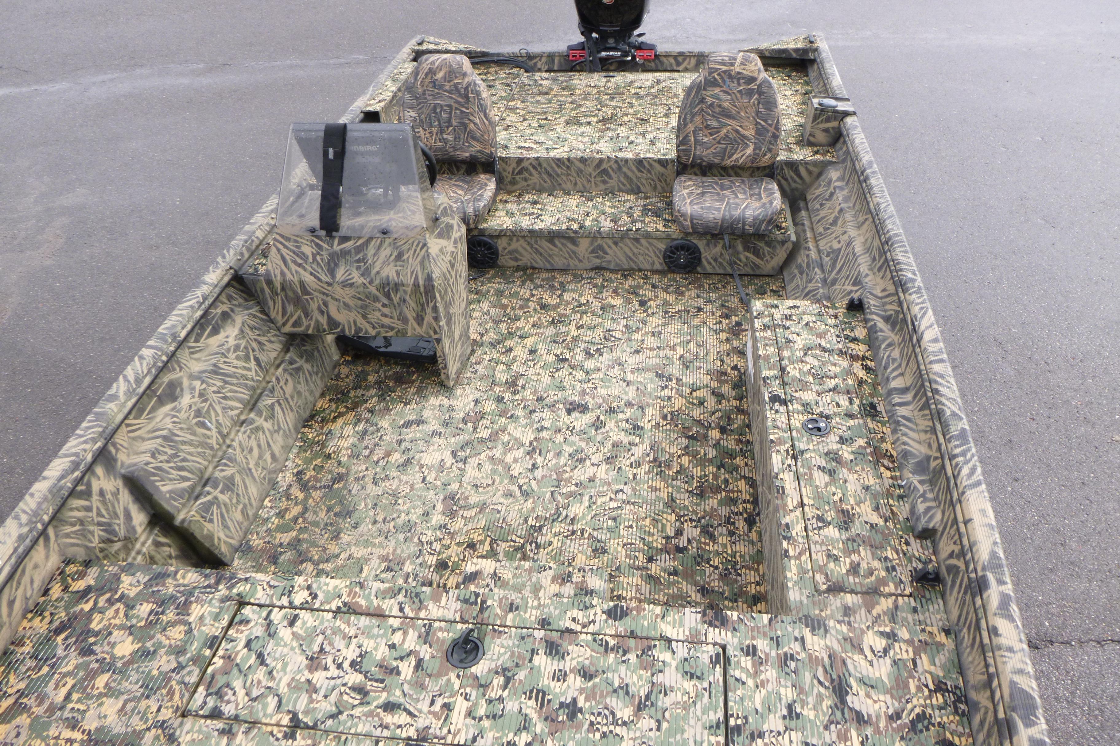 2024 Lowe Roughneck 2070 boat with camouflage interior design, featuring seating and console.