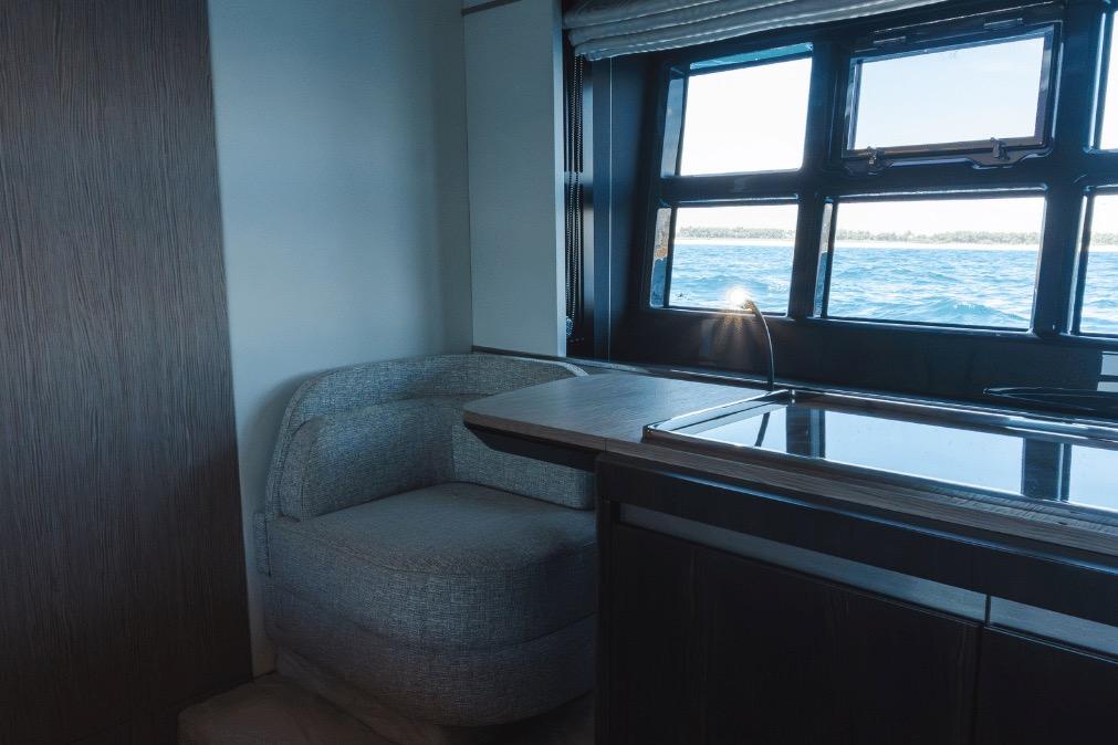 Interior of 2020 Azimut 60 yacht with ocean view through large windows.