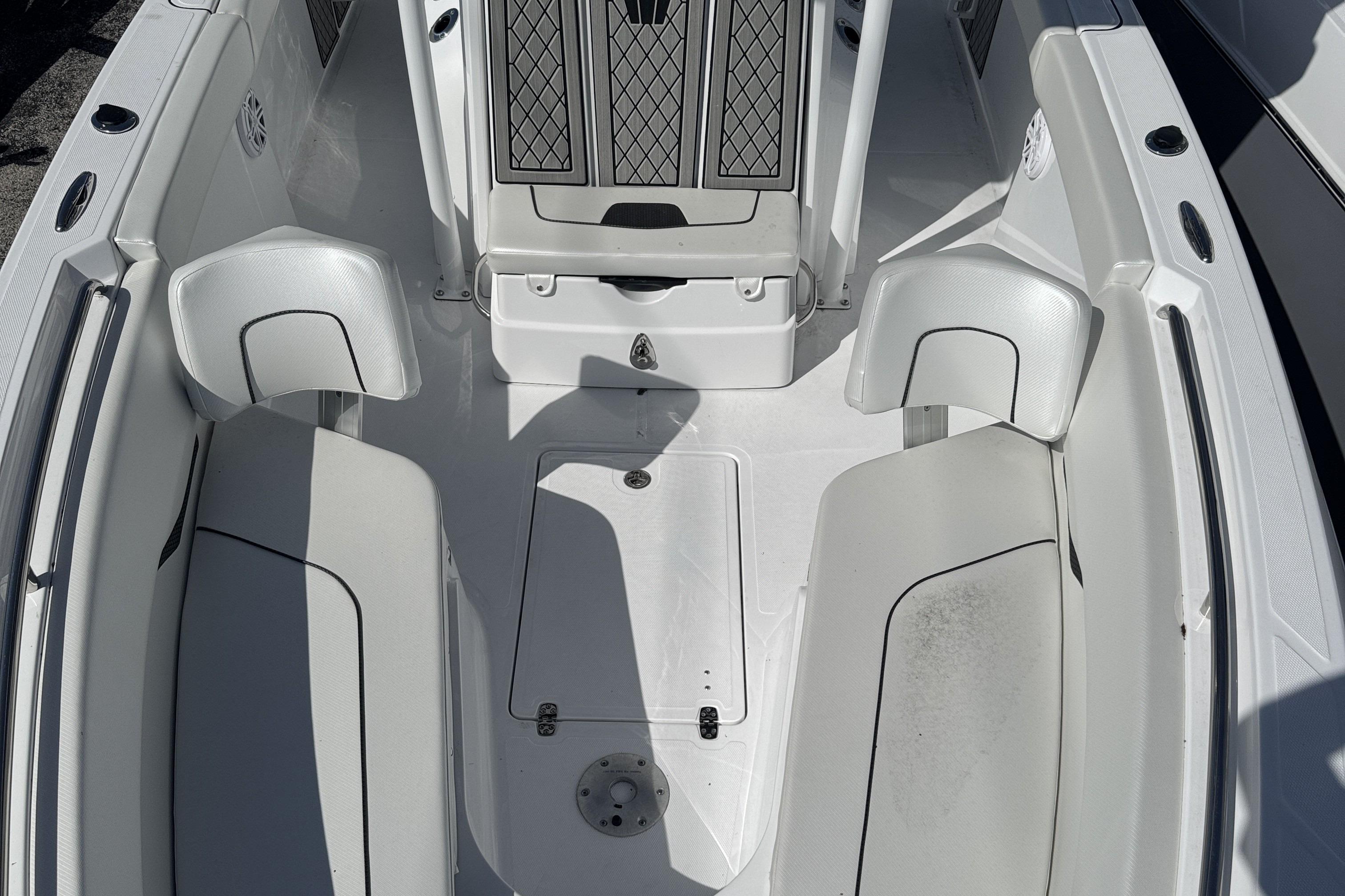 2025 Wellcraft 242 Fisherman boat interior with white seating and storage compartments.