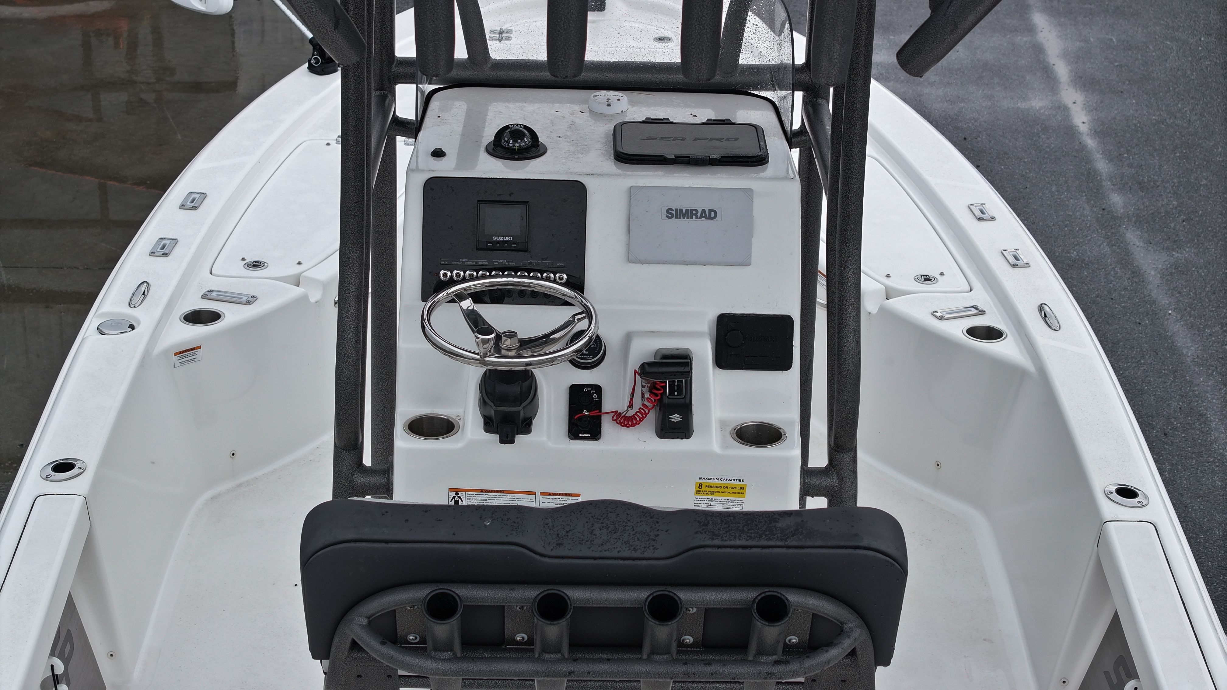 The image shows the cockpit of a Sea Pro 230 DLX boat with controls and instruments.