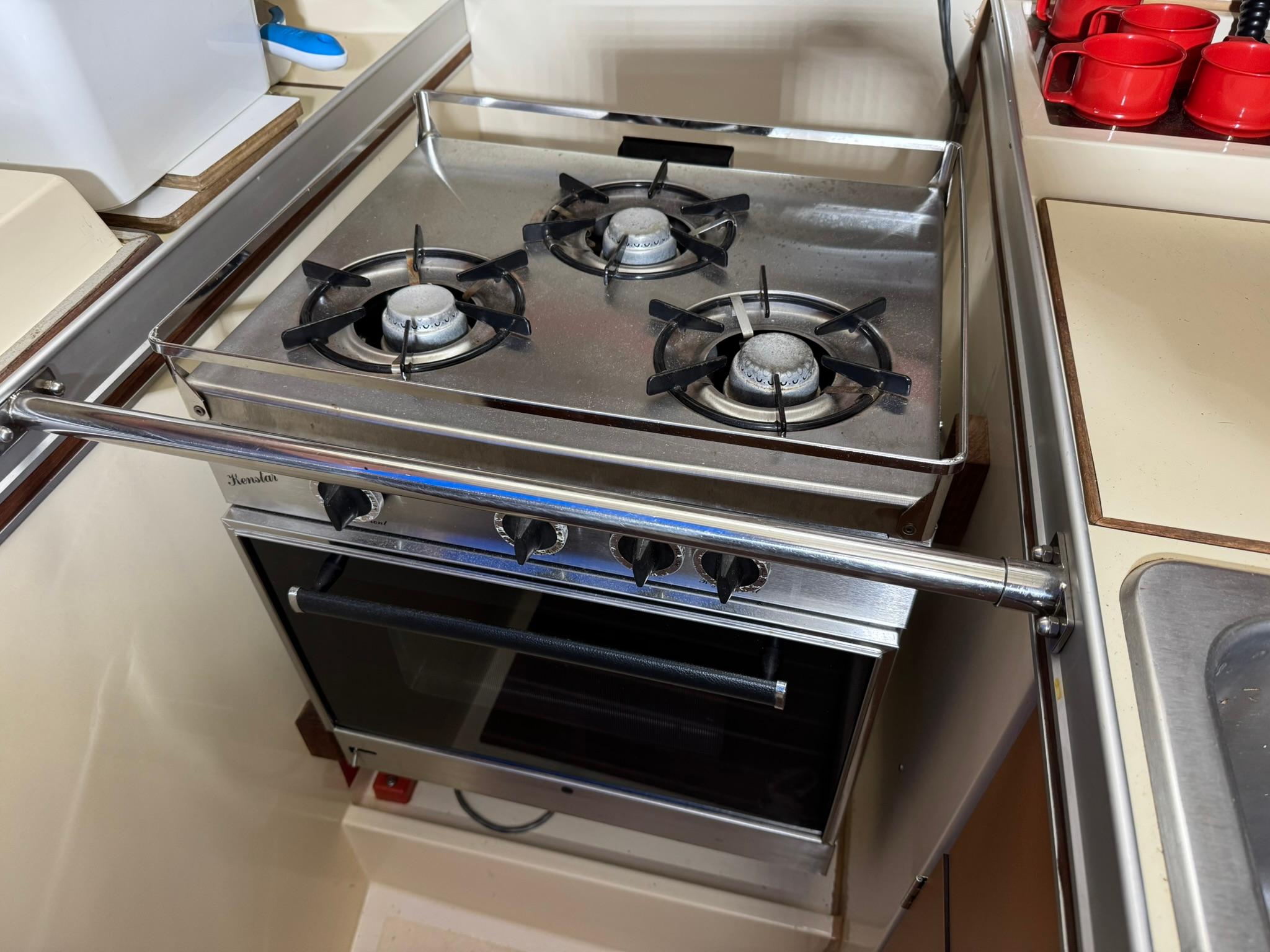 Stove and oven in 1984 Canadian Sailcraft 36 yacht kitchen, featuring three burners.
