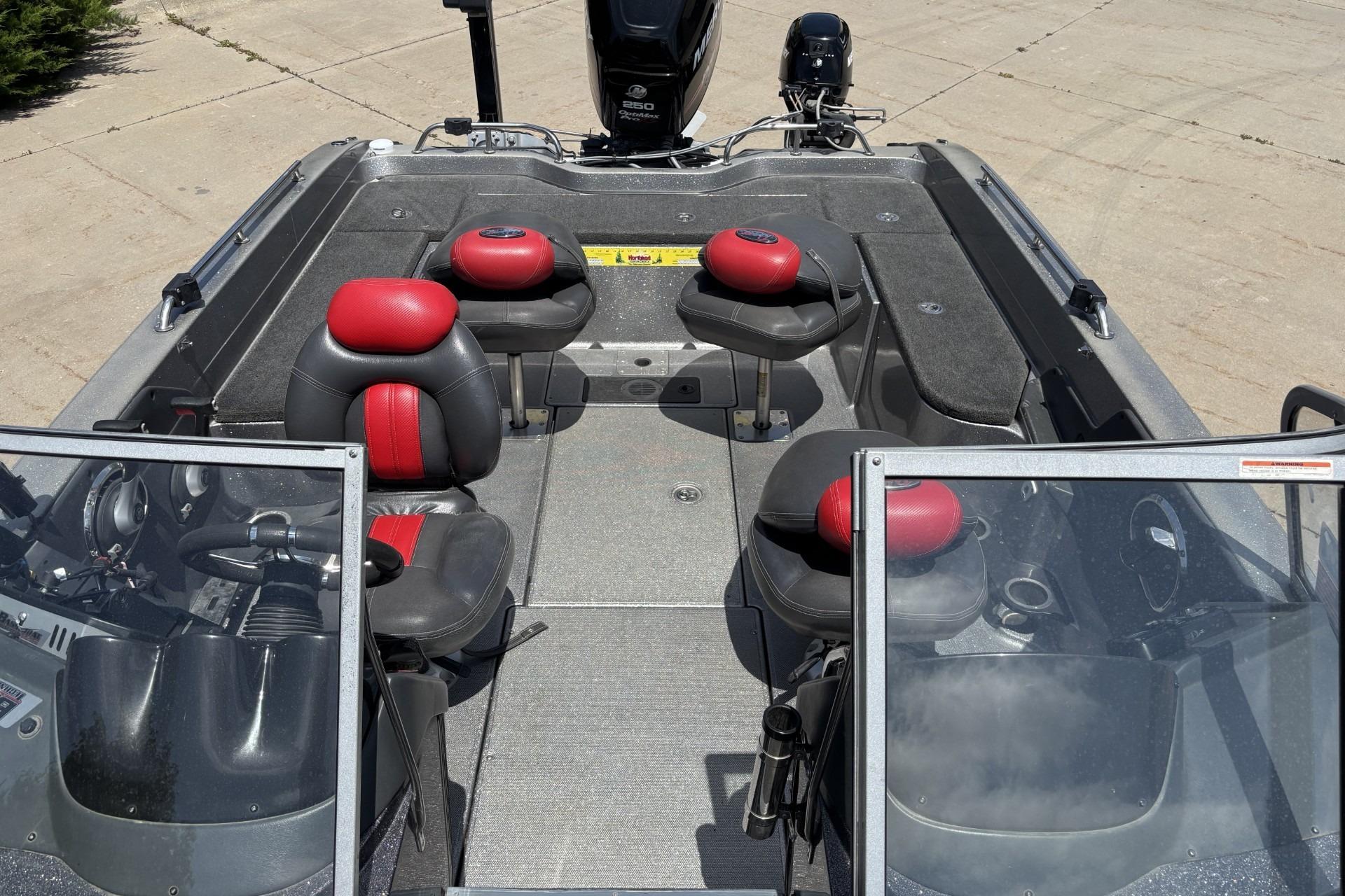 2011 Ranger 620 VS boat interior with red and black seating, open windshield, and motor.
