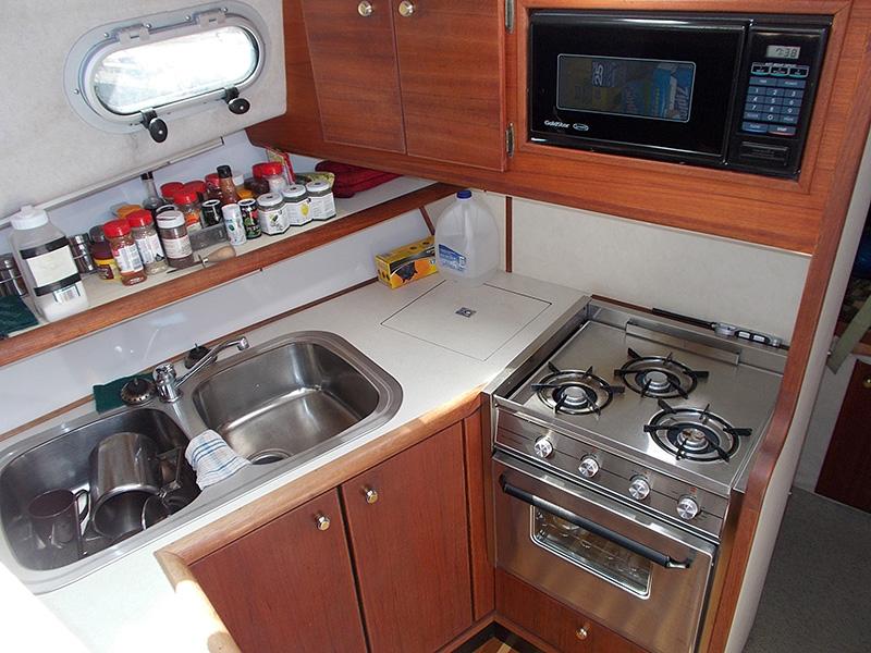 1994 Bayliner 3288 Motoryacht kitchen with stove and microwave.