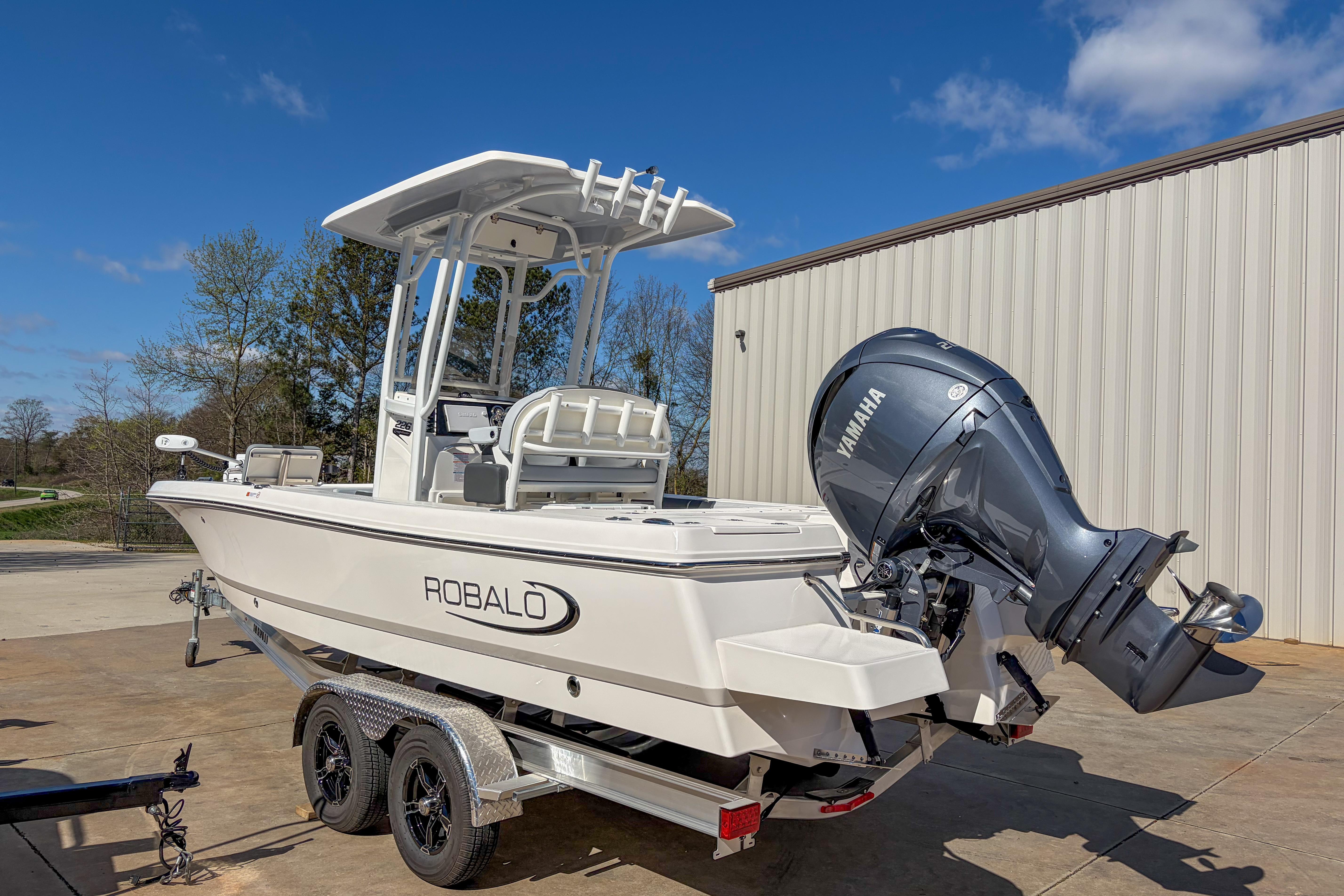 2025 Robalo 226 Cayman boat with Yamaha engine on trailer, parked outdoors.