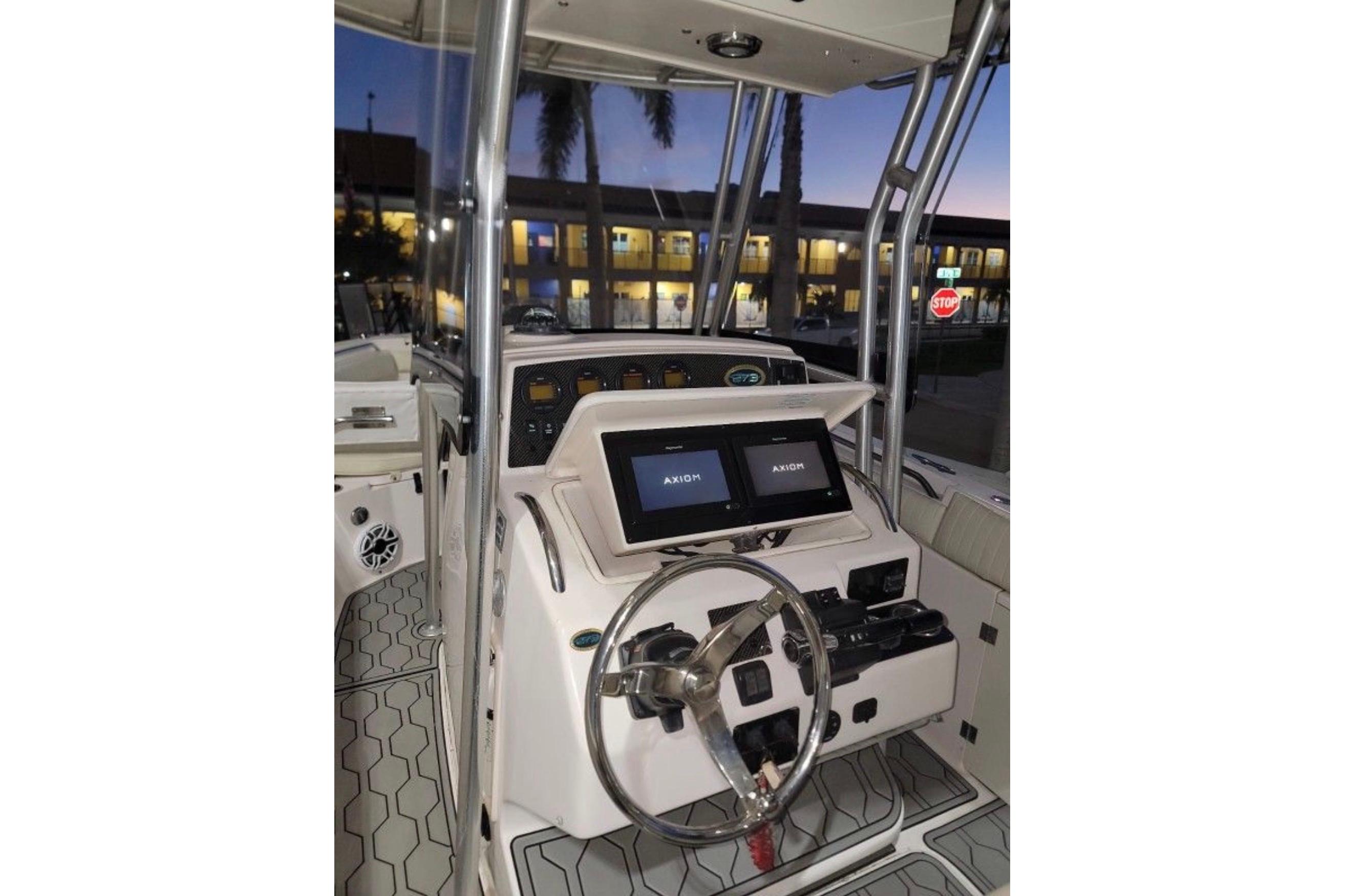 2004 Grady-White Chase 273 boat cockpit with dual Axiom displays at dusk.
