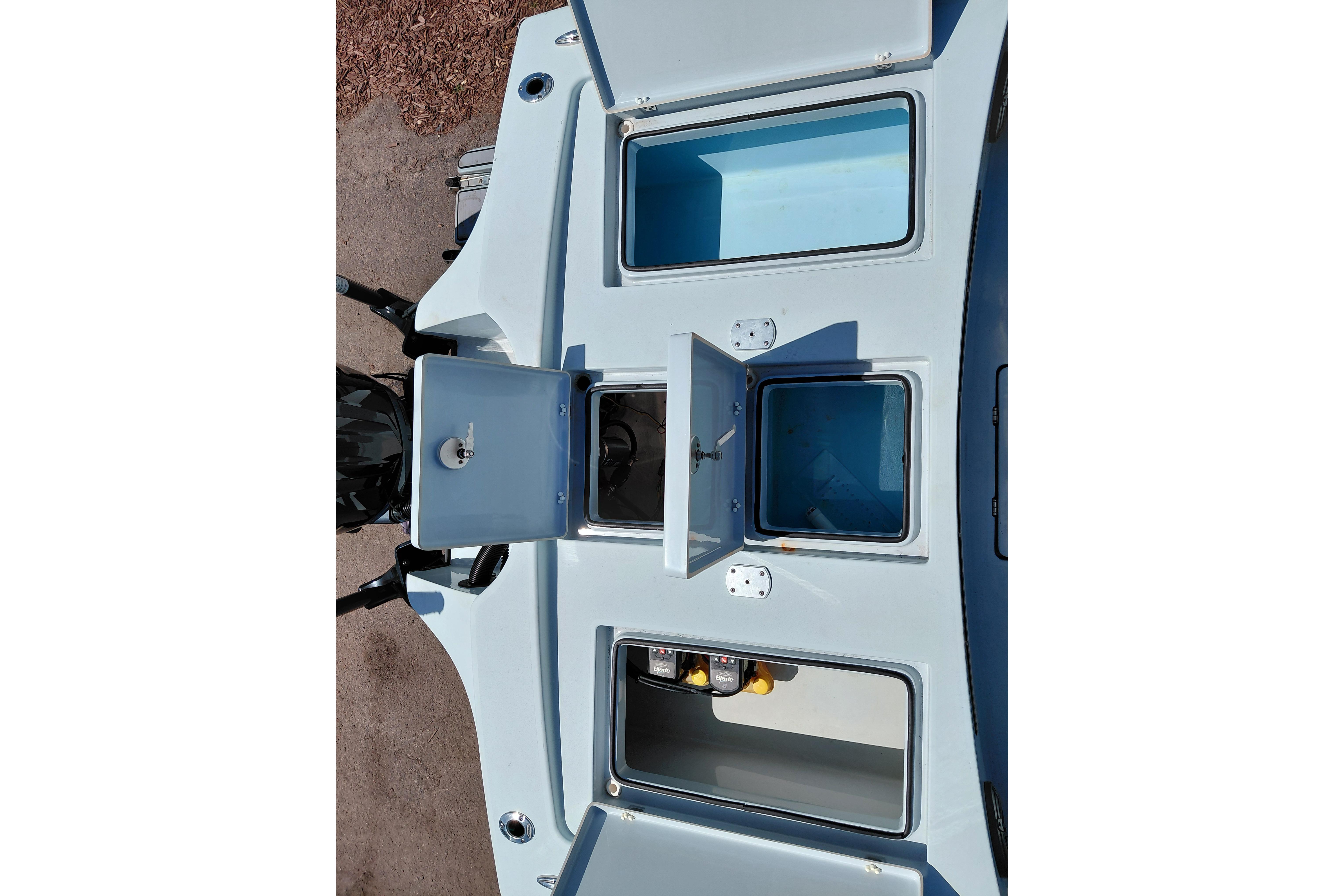 2022 Pathfinder 2300 HPS boat with open storage compartments, top view.